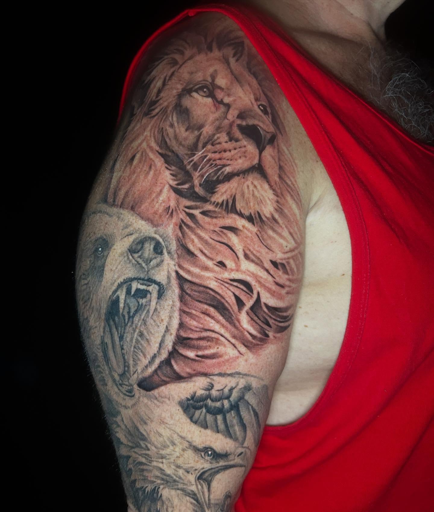 Lion and bear realism tattoo on the shoulder by Mayhem Andrews
