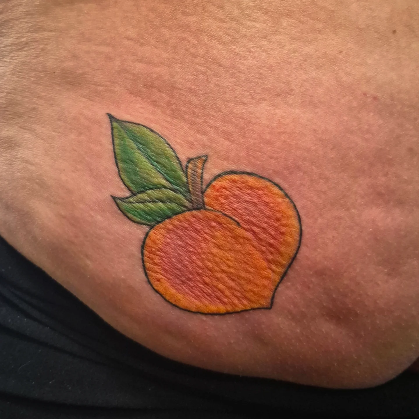 Peach realism tattoo on the chest by Lydia Kiley