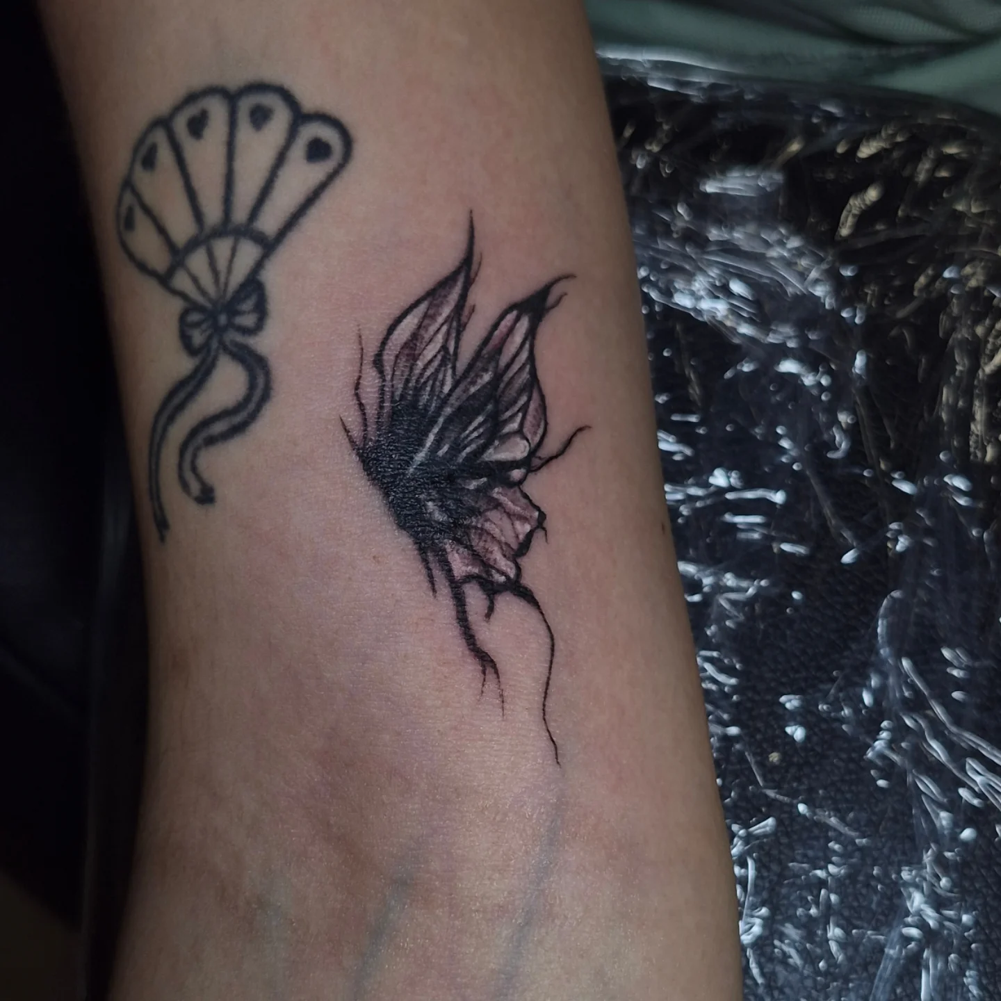 Butterfly black and grey tattoo on the forearm by Lydia Kiley