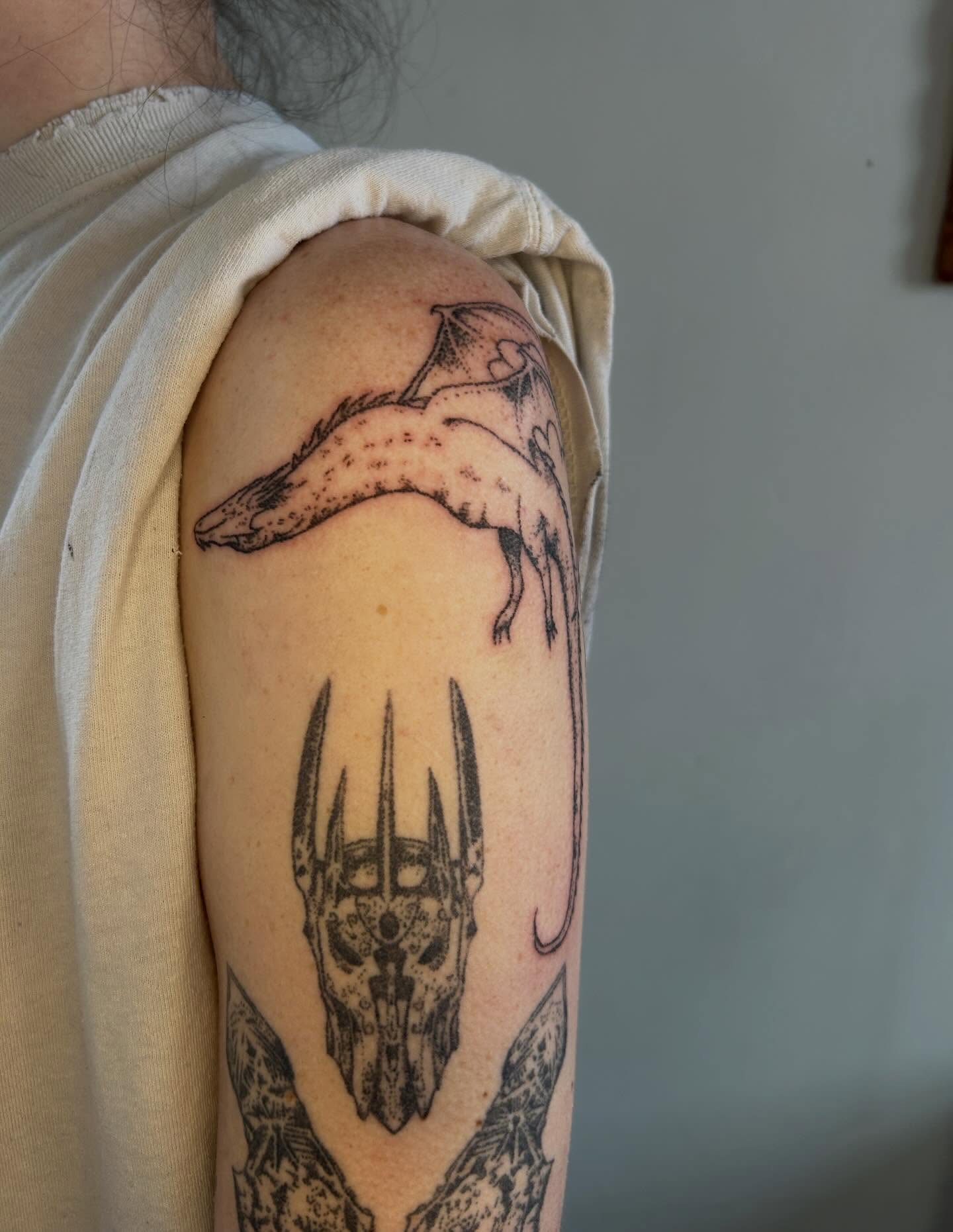 Demon skull and dragon dark realism tattoo on the upper arm by ˙⋆✮⋆˙‧₊˚✧ sophie ✧˚₊‧˙⋆✮⋆˙