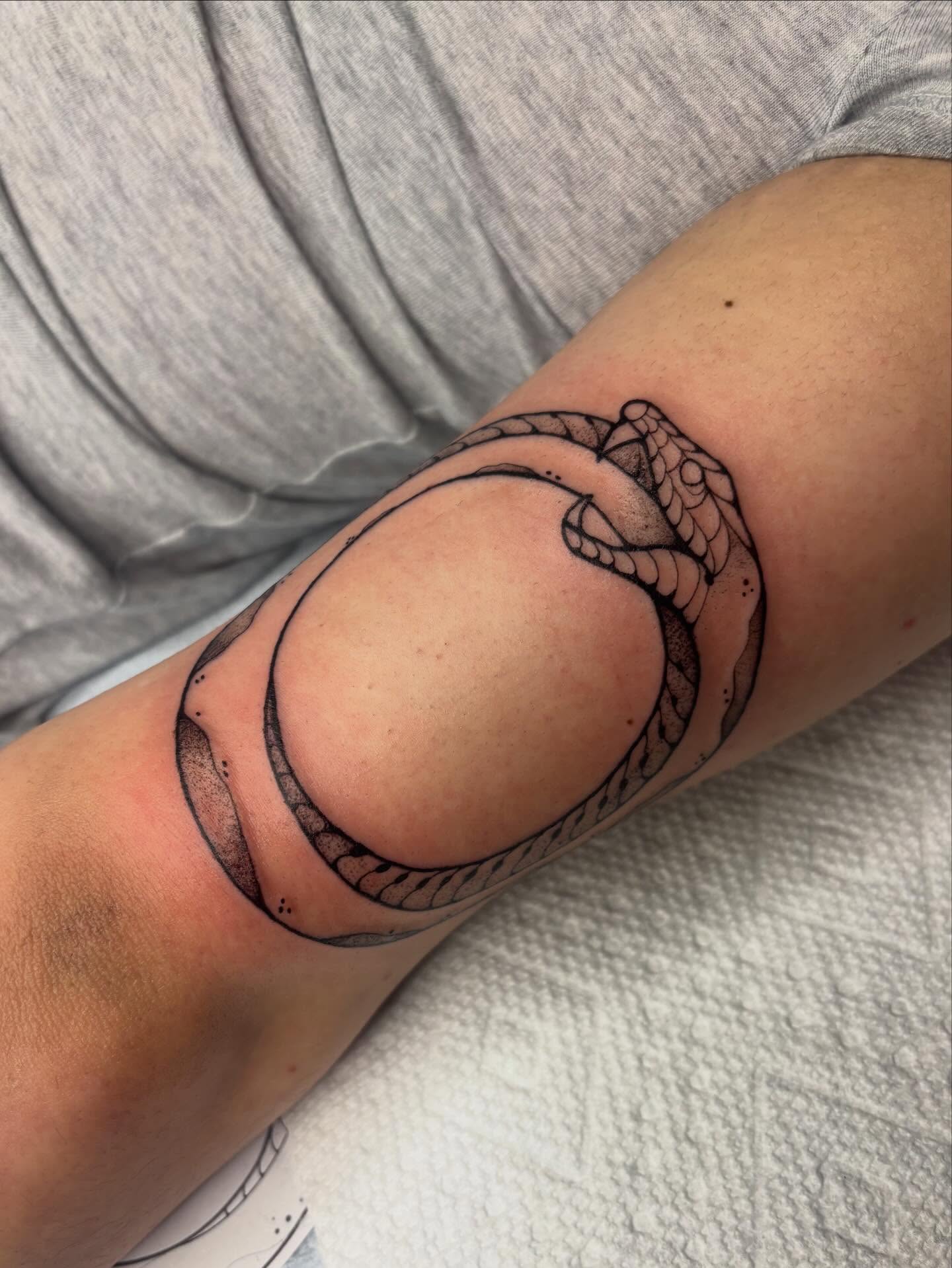 Snake black and grey tattoo on the forearm by Emmy Gallagher
