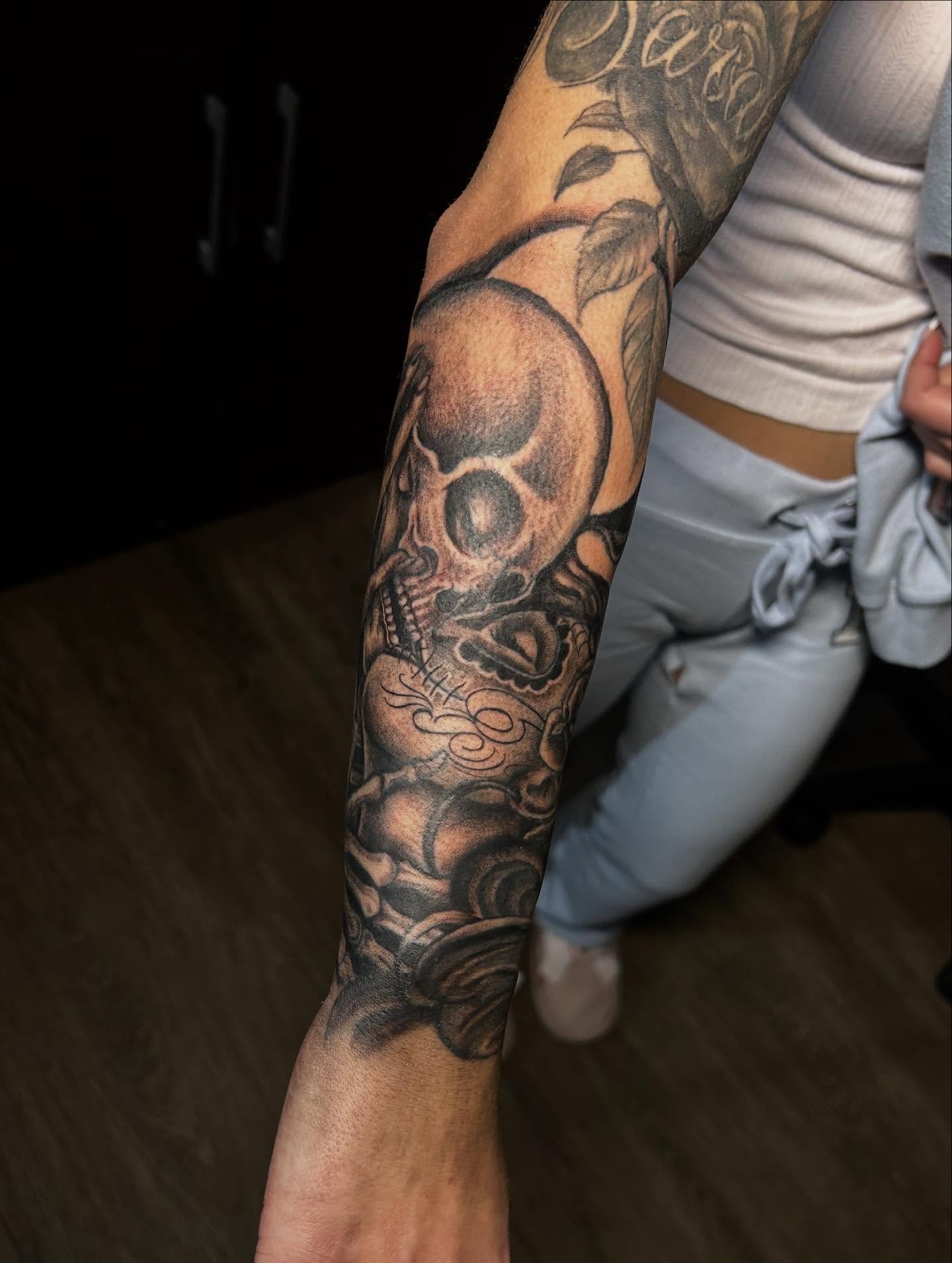 Skull black and grey tattoo on the forearm by Ximena Favela