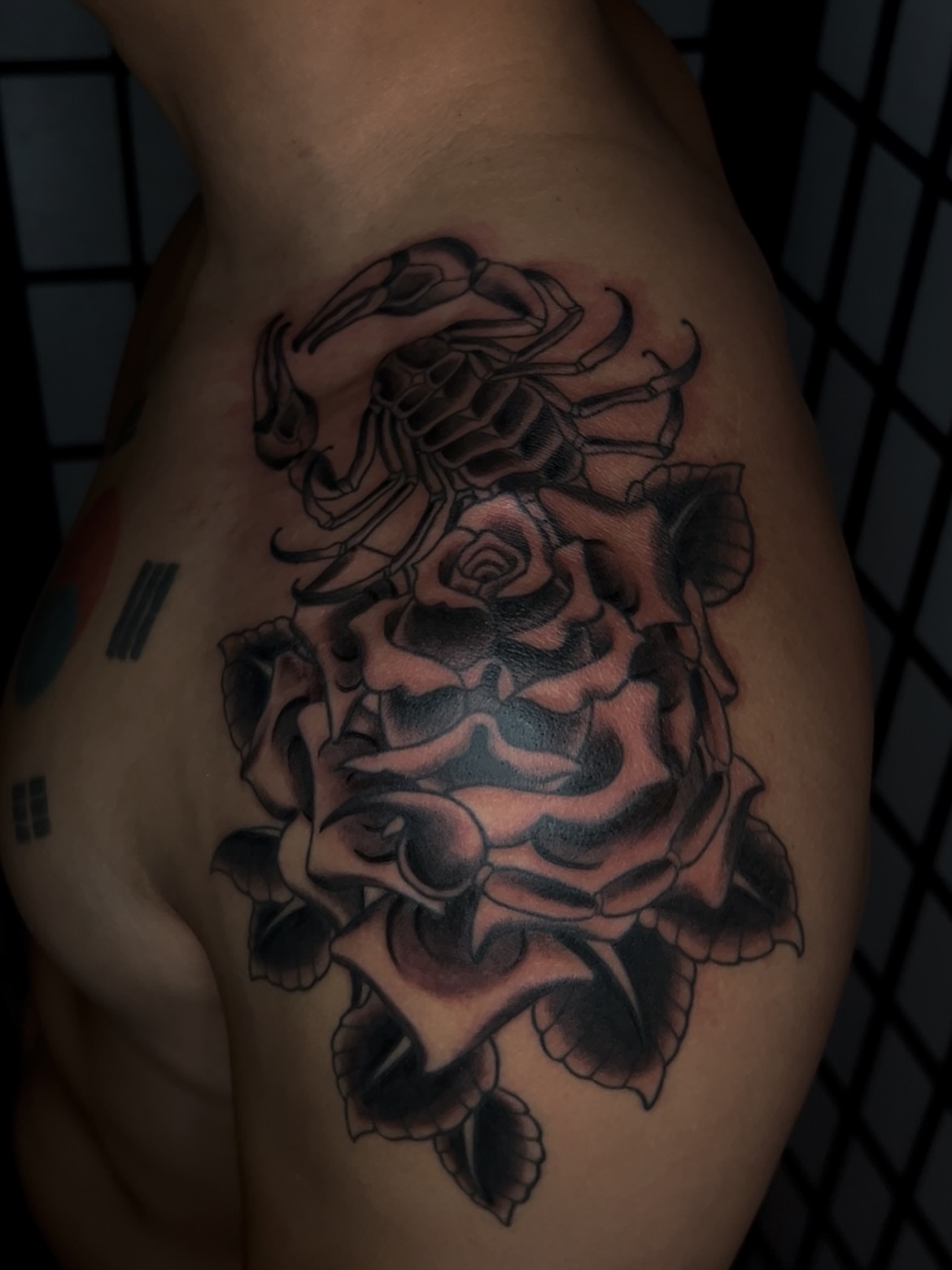 Rose realism tattoo on the thigh by Vic Merkley