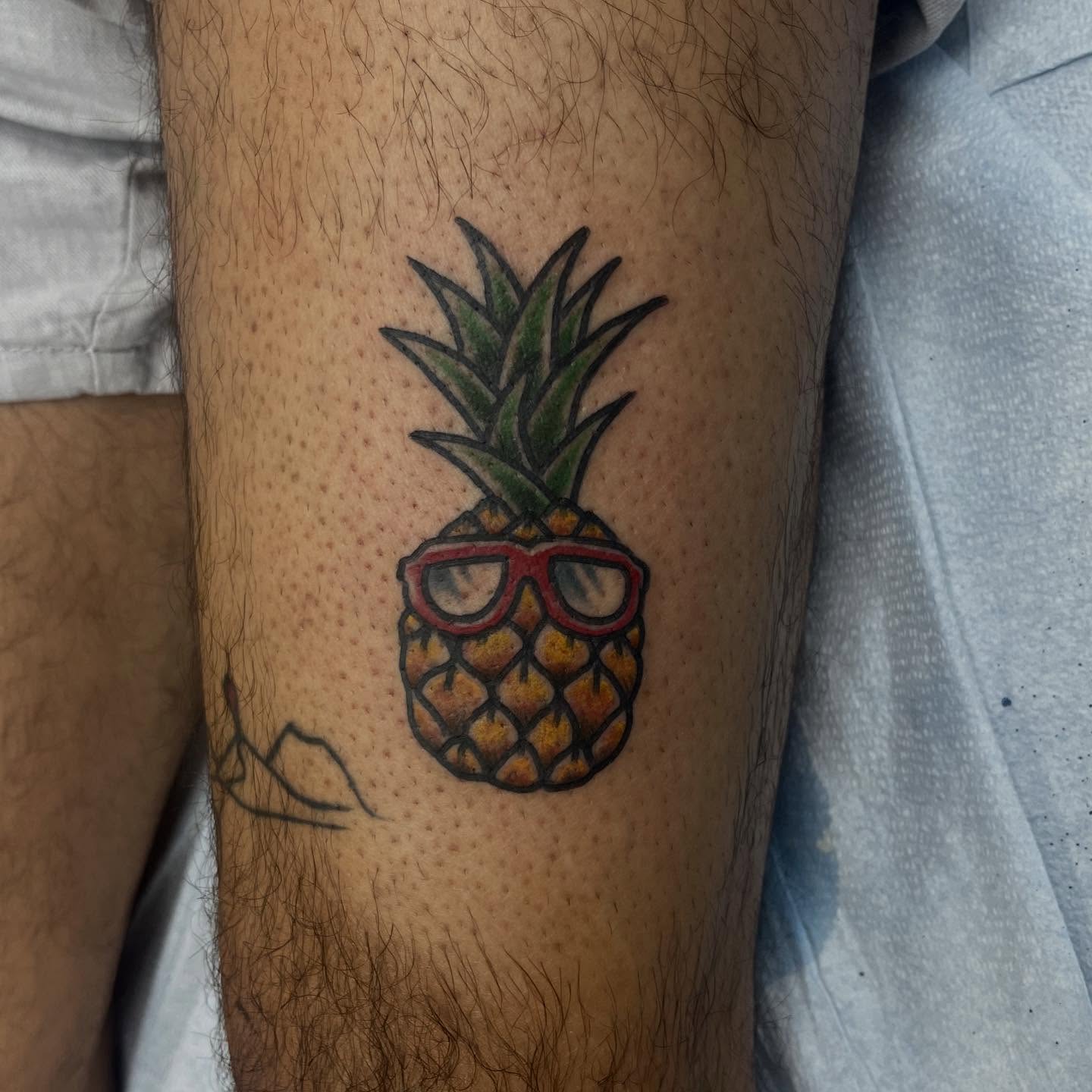 Pineapple wearing glasses new school tattoo on the forearm by Franky Sharpz