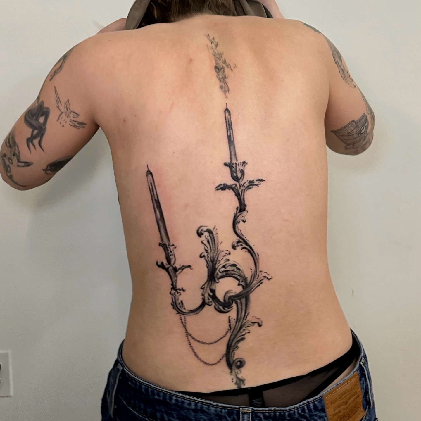 Candle chandelier ornamental tattoo on the back by kale