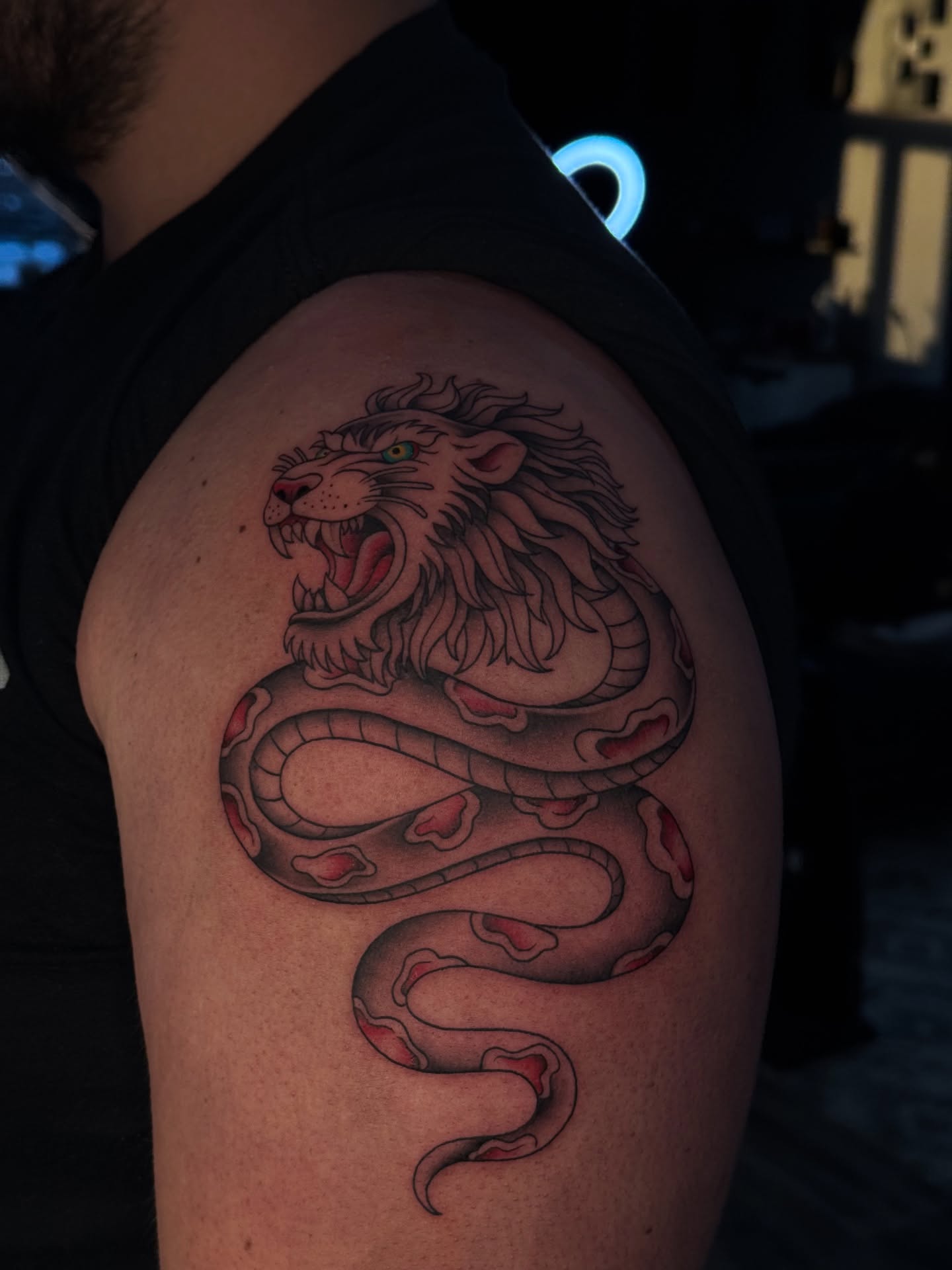 Lion and snake American traditional tattoo on the shoulder by 𝔍𝔲𝔩𝔦𝔞, New York, New York