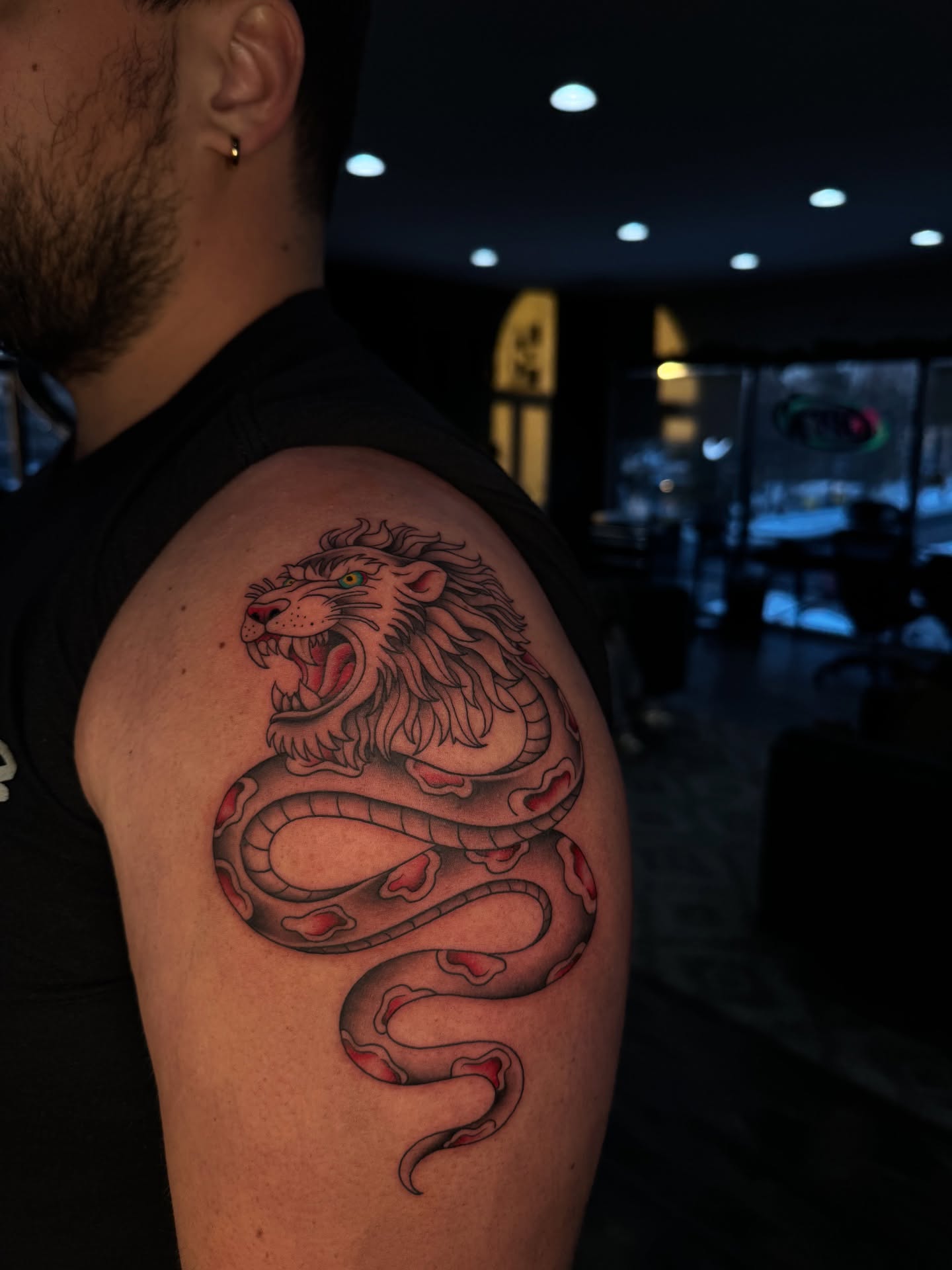 Lion and snake realism tattoo on the shoulder by 𝔍𝔲𝔩𝔦𝔞, New York, New York