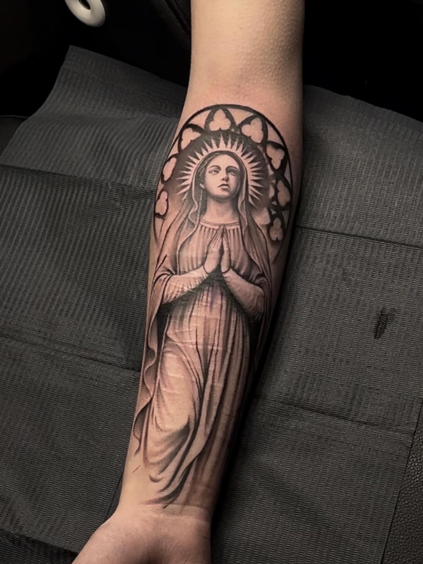 Religious figure black and grey tattoo on the forearm by Turk