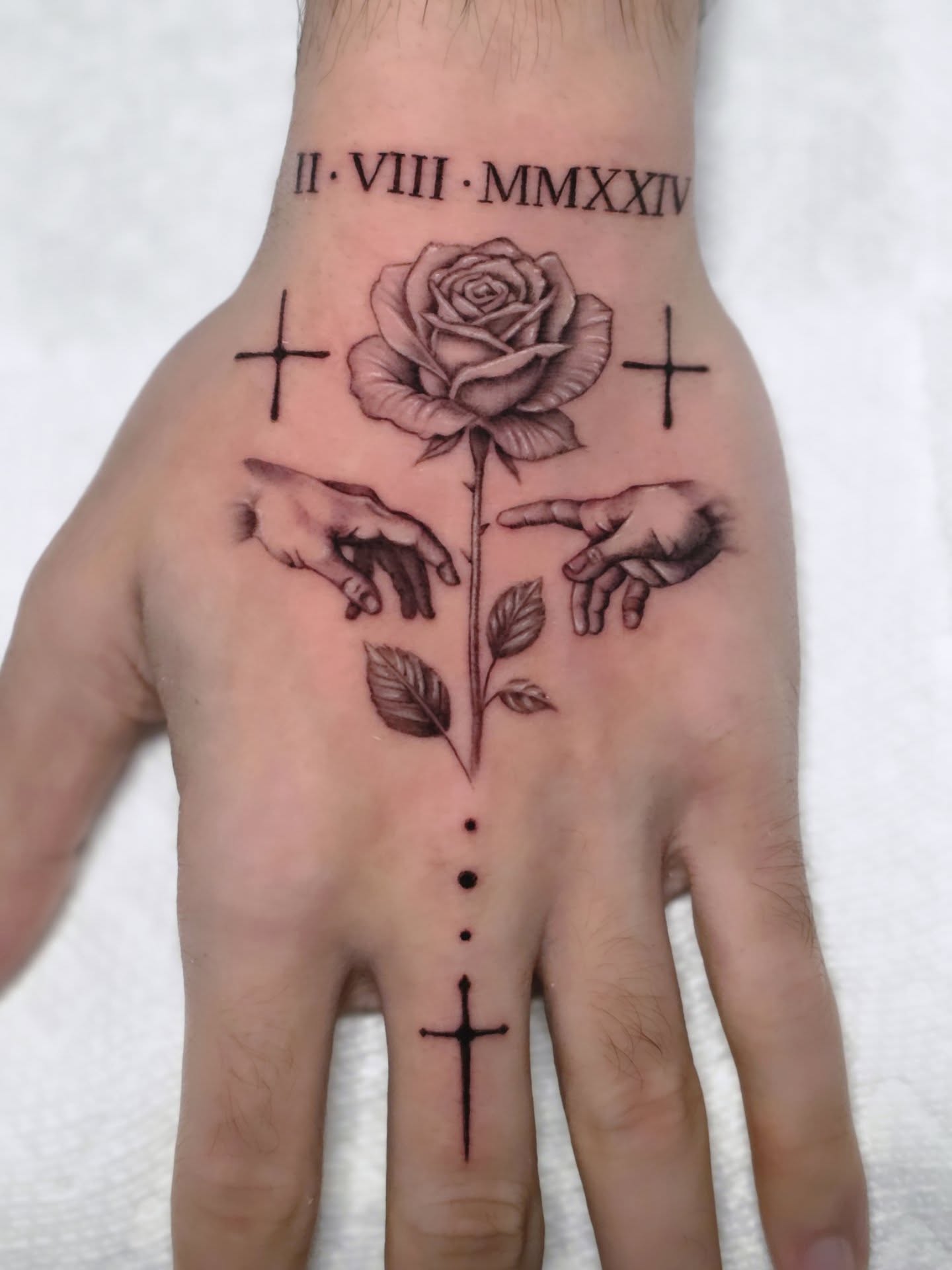 Rose with hands and crosses dotwork tattoo on the hand by Jake Barney