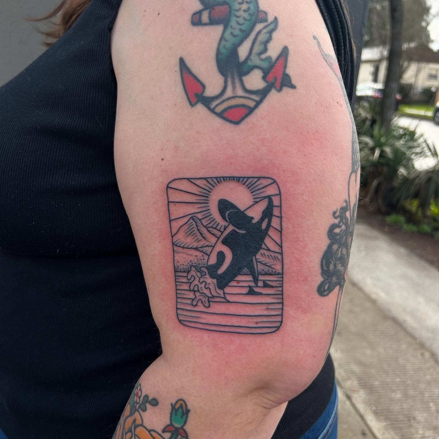 Whale and sun American traditional tattoo on the forearm by Erica Finley