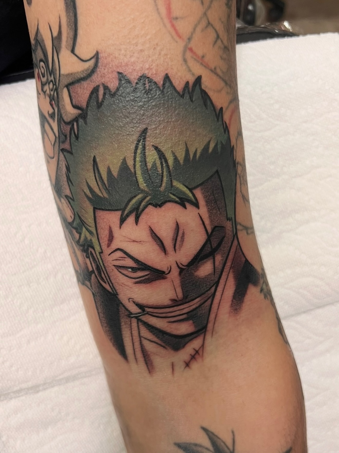 Anime character anime tattoo on the forearm by Jake lyon