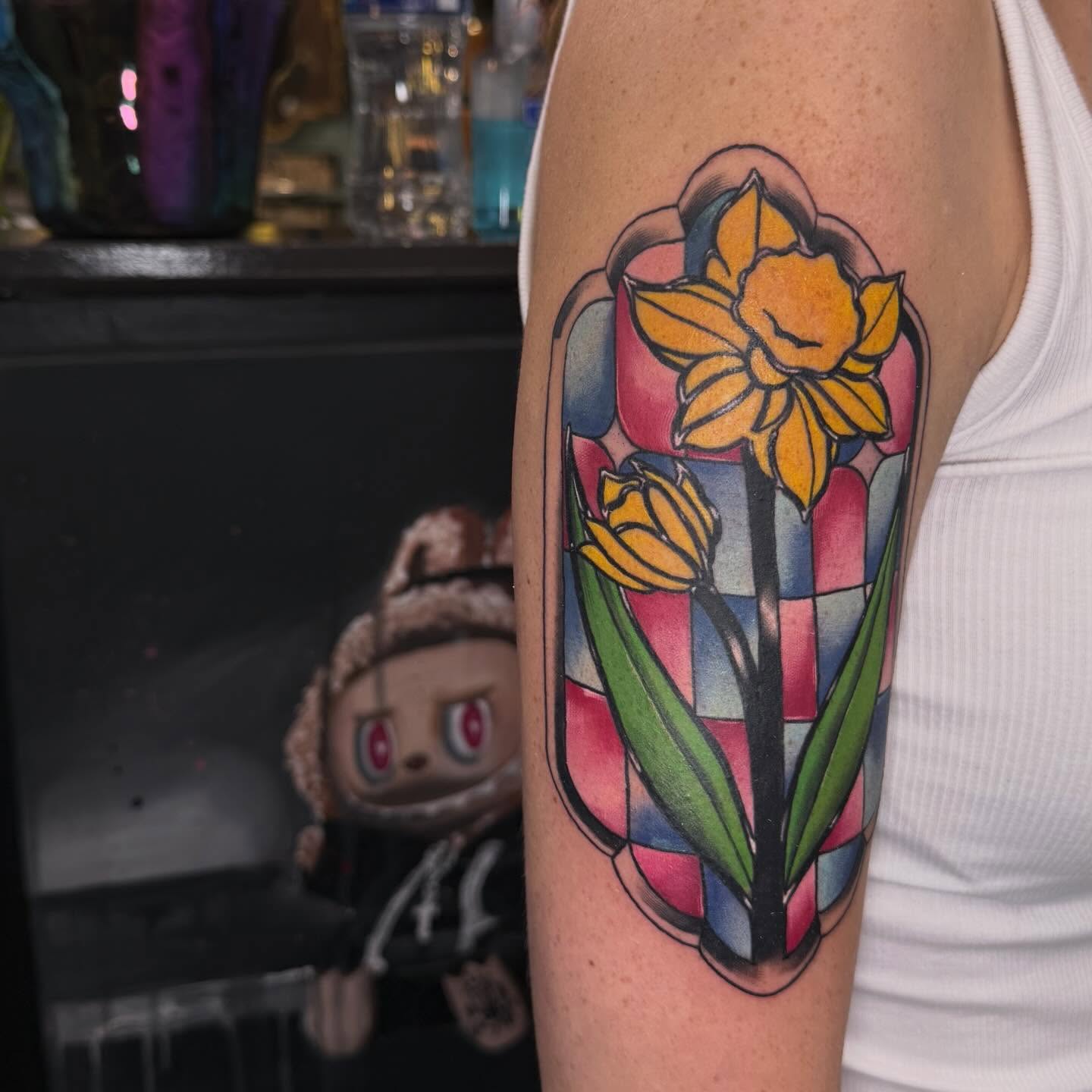 Stained glass daffodils geometric tattoo on the forearm by Lu Ve, Dayton, Ohio