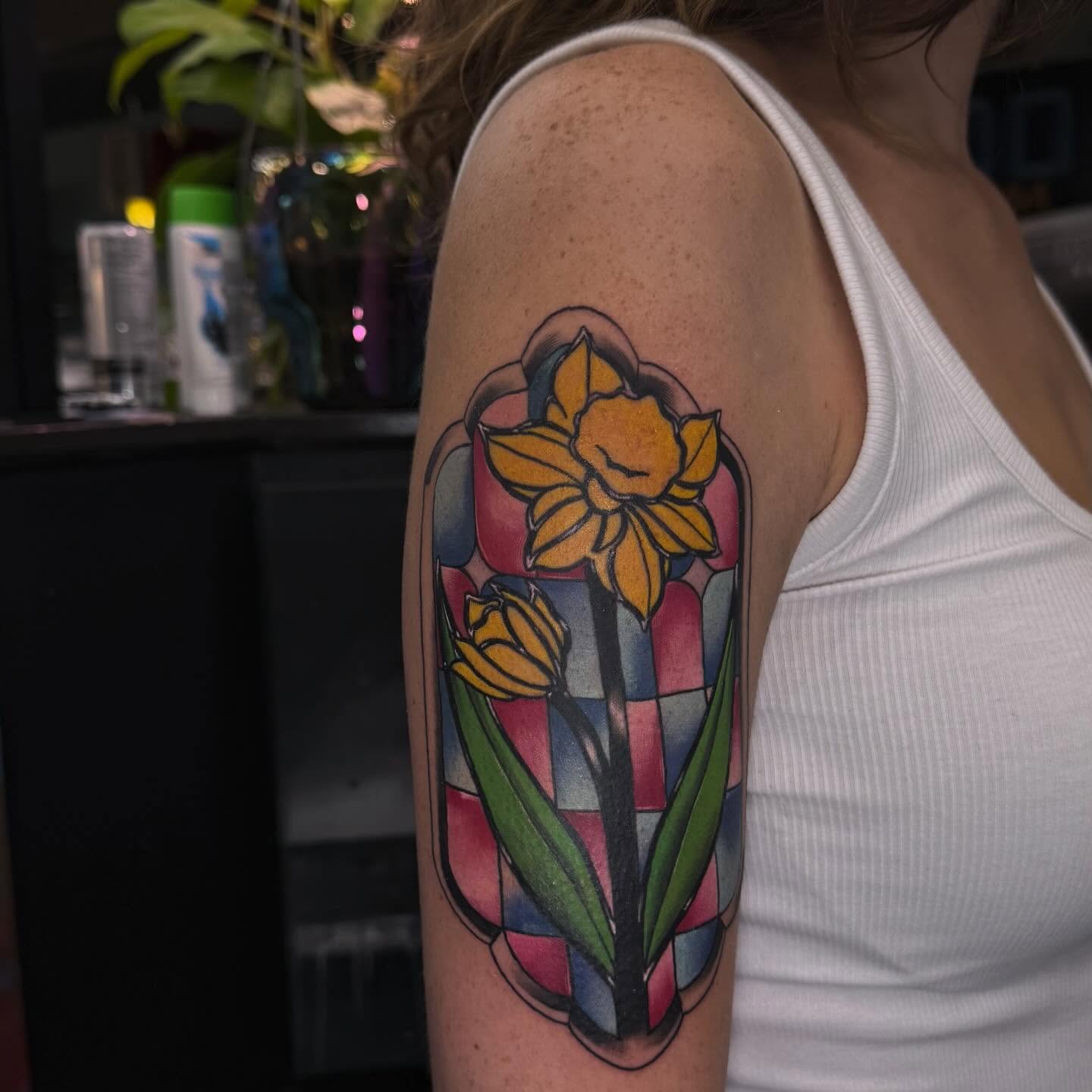 Daffodils geometric tattoo on the upper arm by Lu Ve, Dayton, Ohio