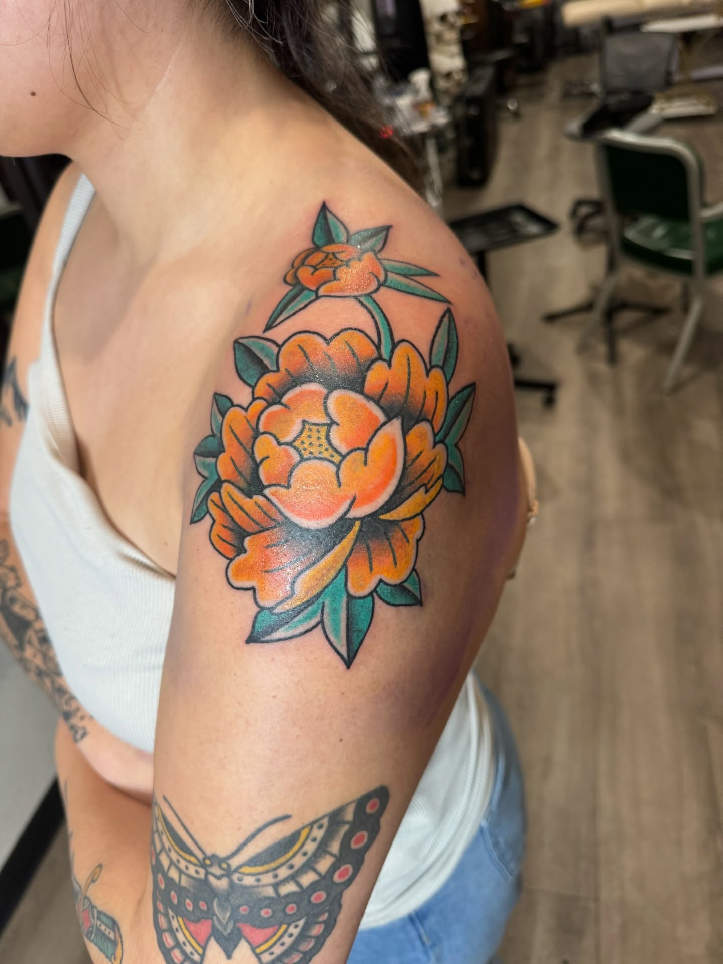 Peony American traditional tattoo on the shoulder by Minneapolis