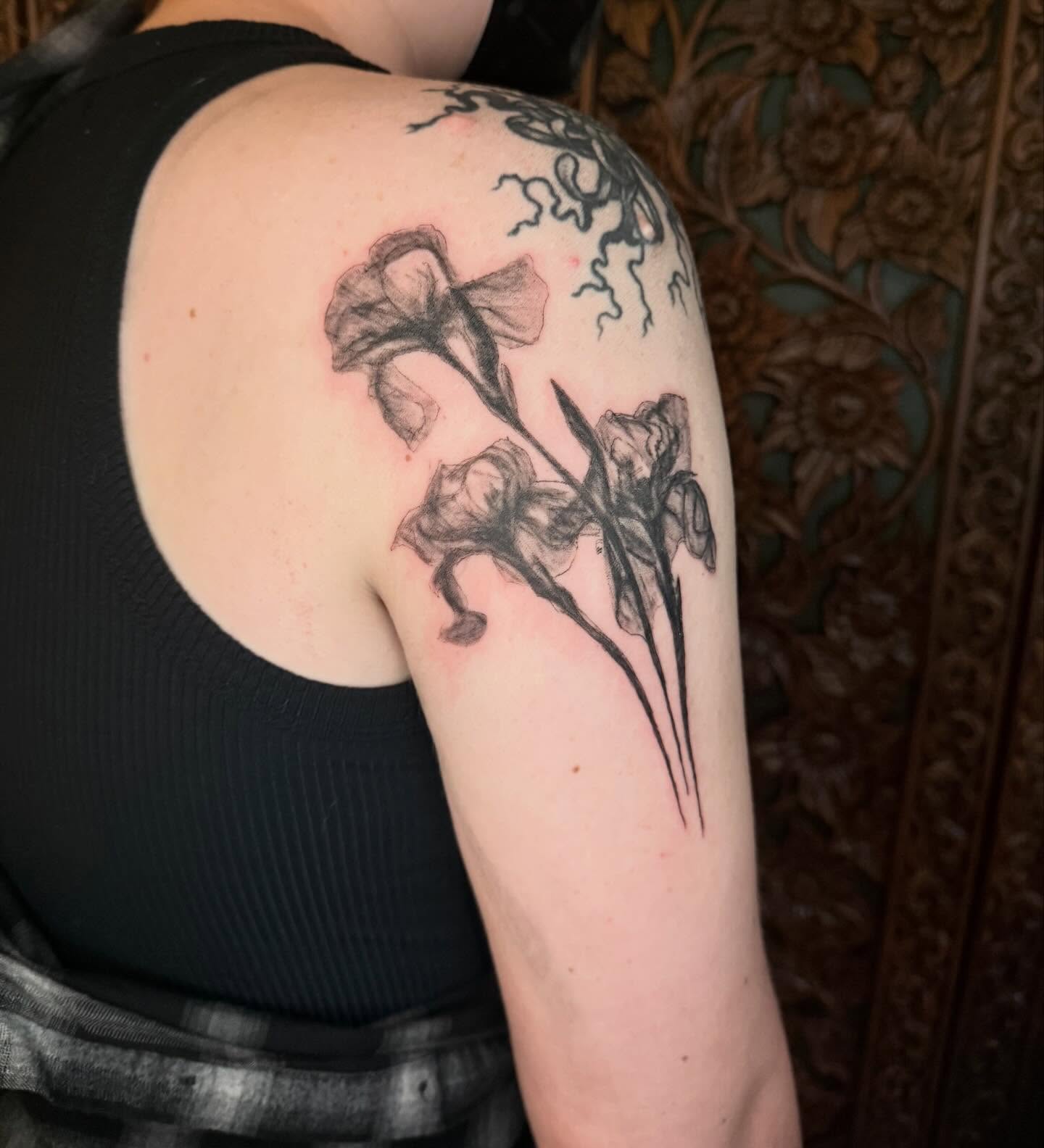 Iris black and grey tattoo on the shoulder by Emily Rose Lumsdaine