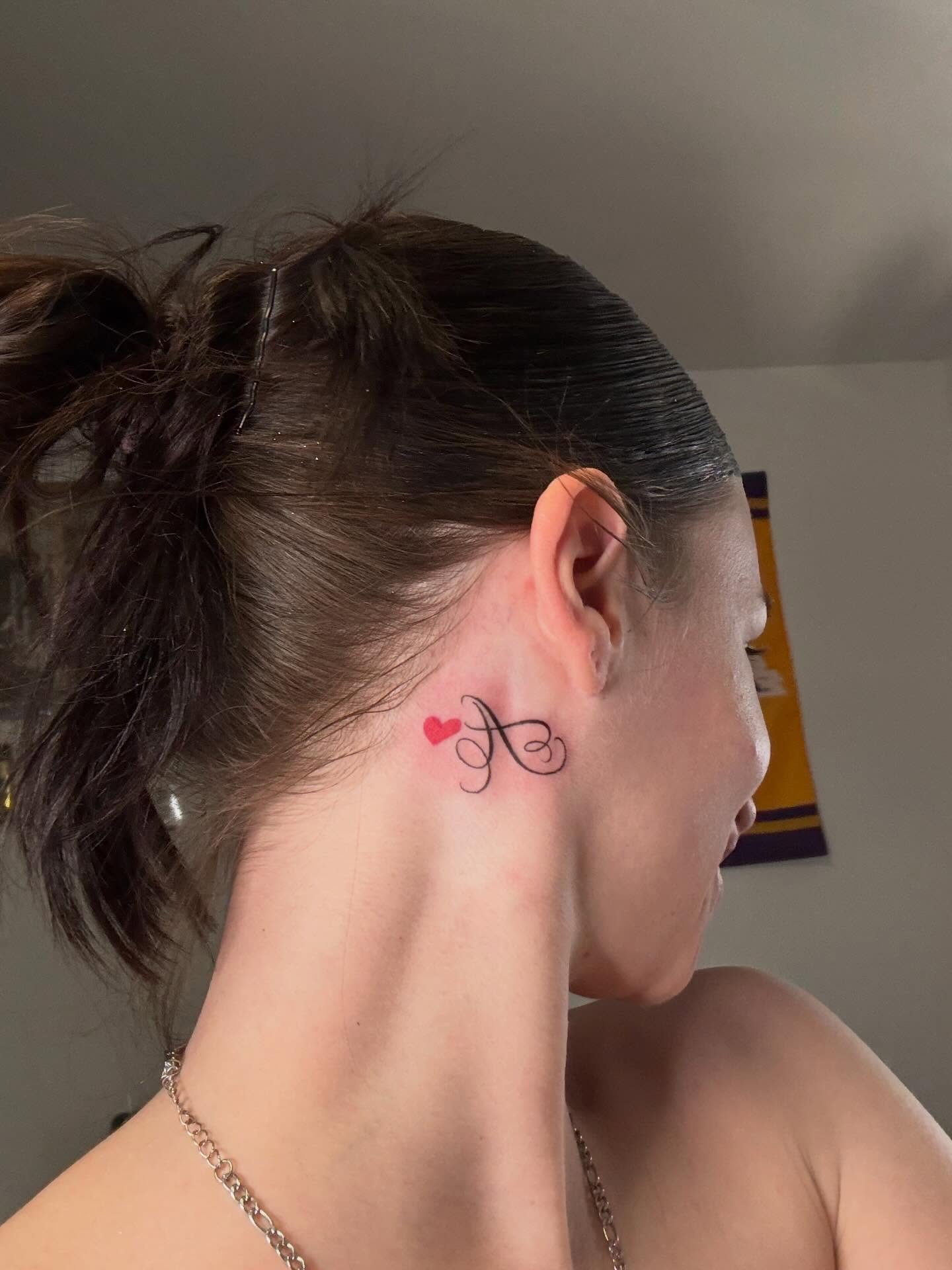 Initial with heart lettering script tattoo on the neck by Rae Reeezy😈