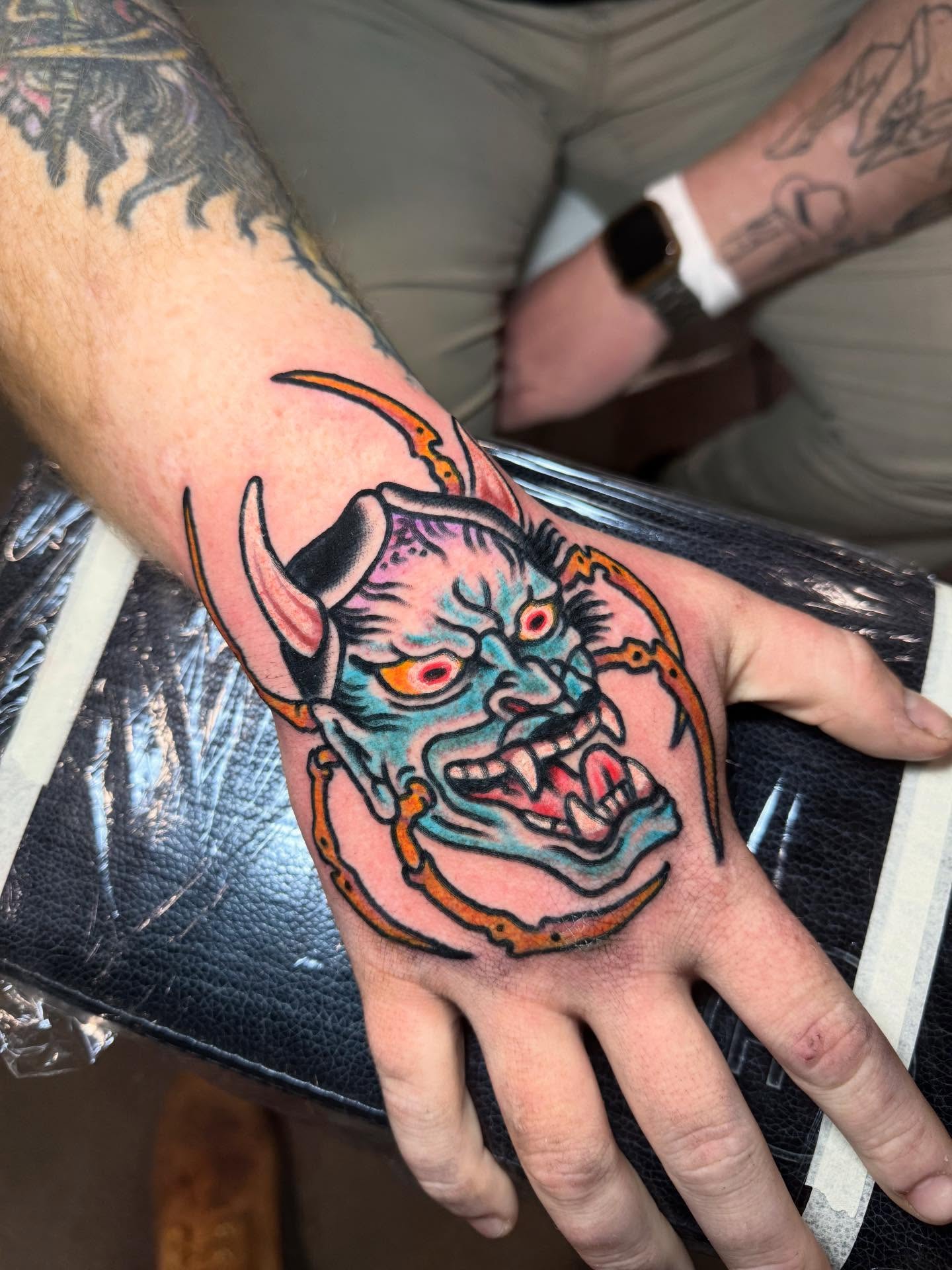 Demon mask American traditional tattoo on the hand by Jonathan Clapp, San Antonio, Texas