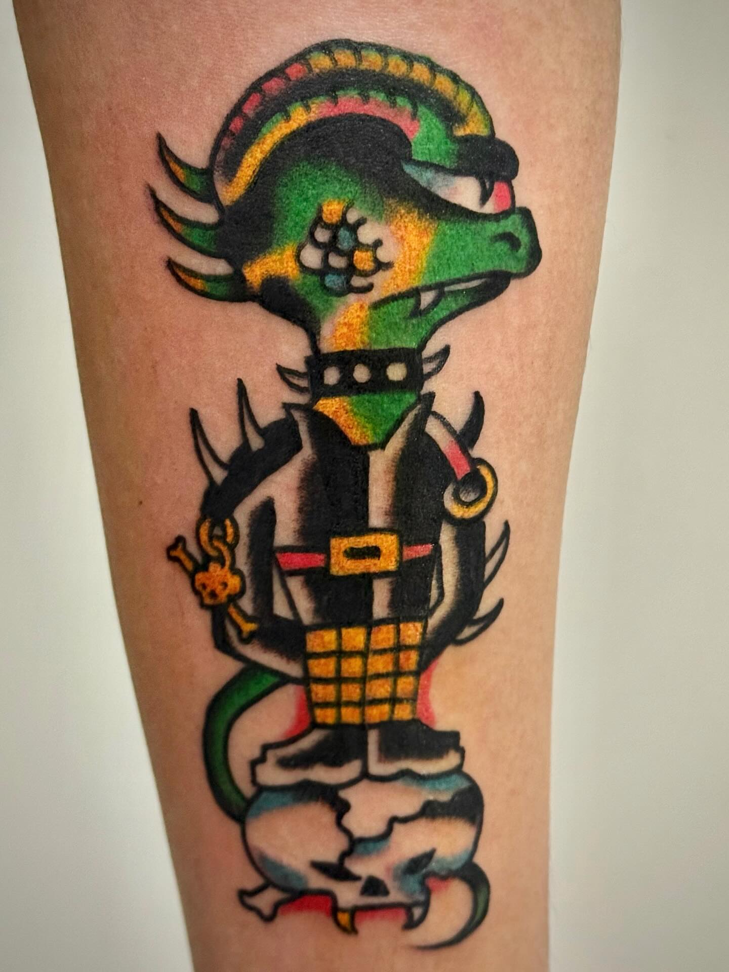 Lizard-like creature American traditional tattoo on the forearm by JAX