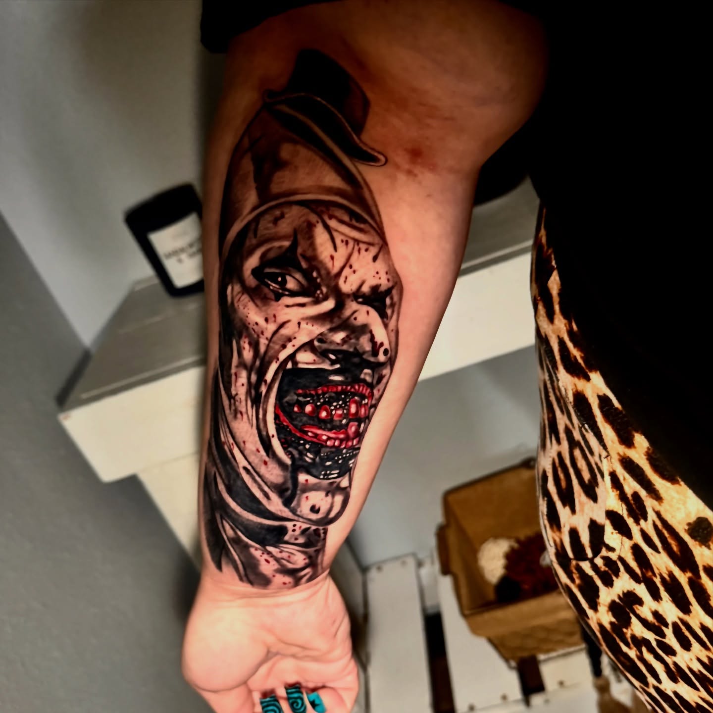 Angry clown realism tattoo on the forearm by Tampa tattoo artist