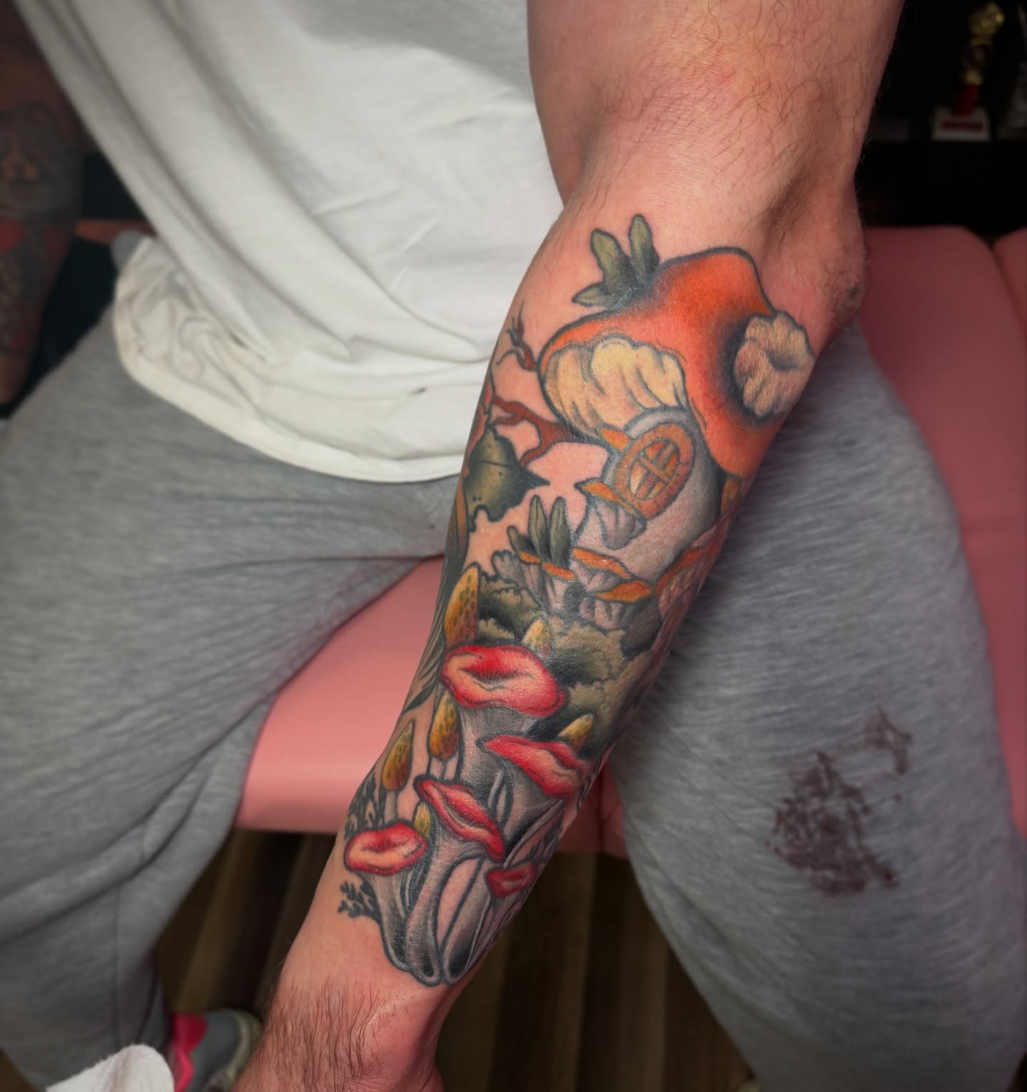 Tomato and flowers American traditional tattoo on the forearm by Lyndze Masters