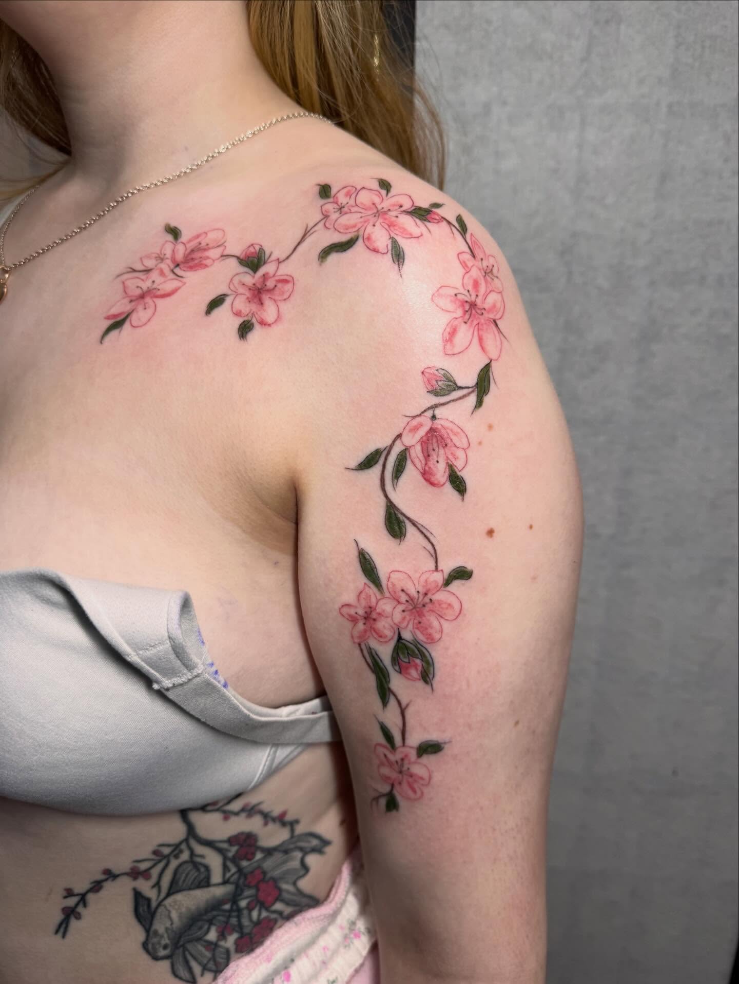 Cherry blossoms realism tattoo on the shoulder by olivia reed