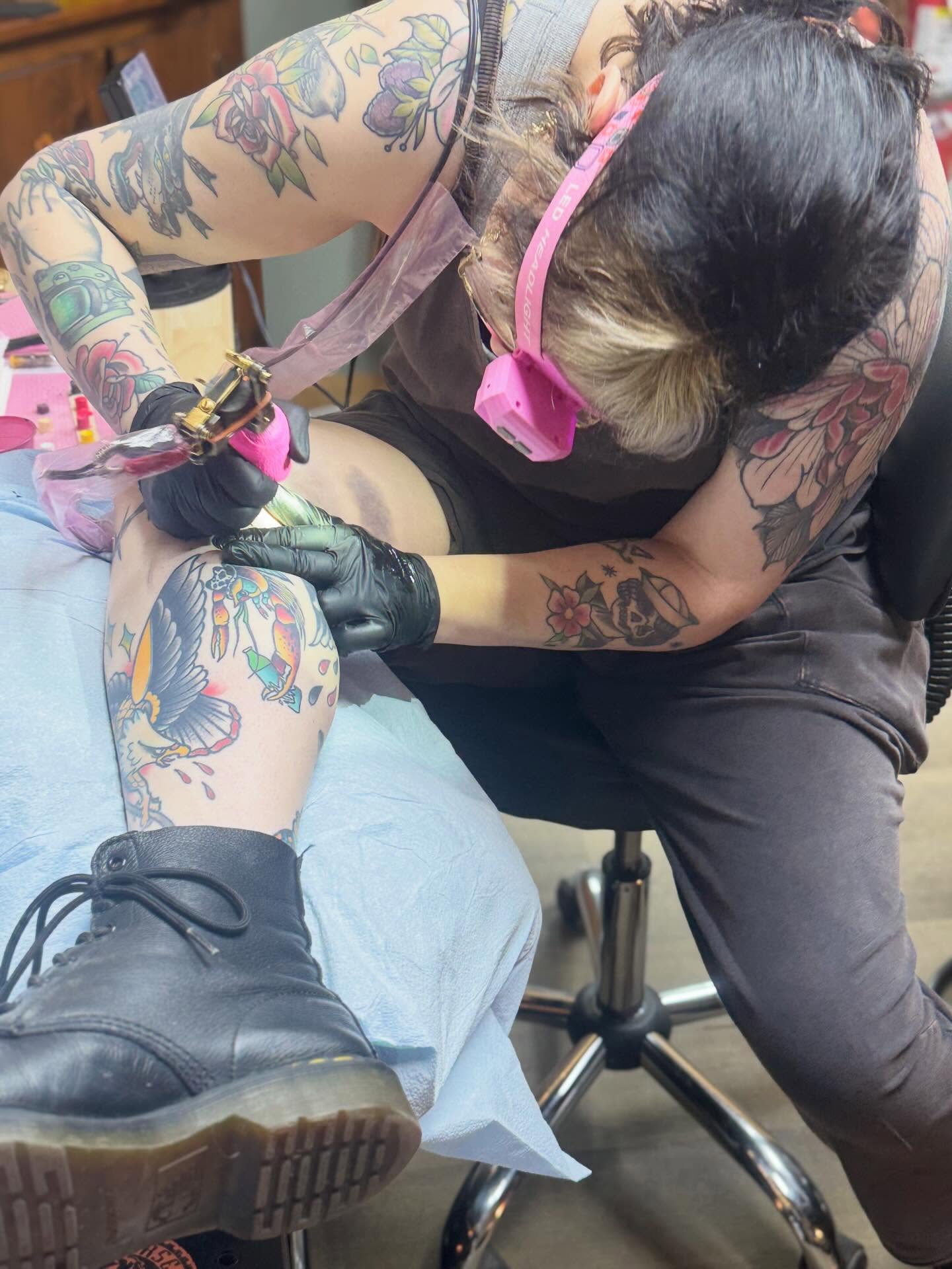 Bird and floral American traditional tattoo on the thigh by Ash Sansoucie