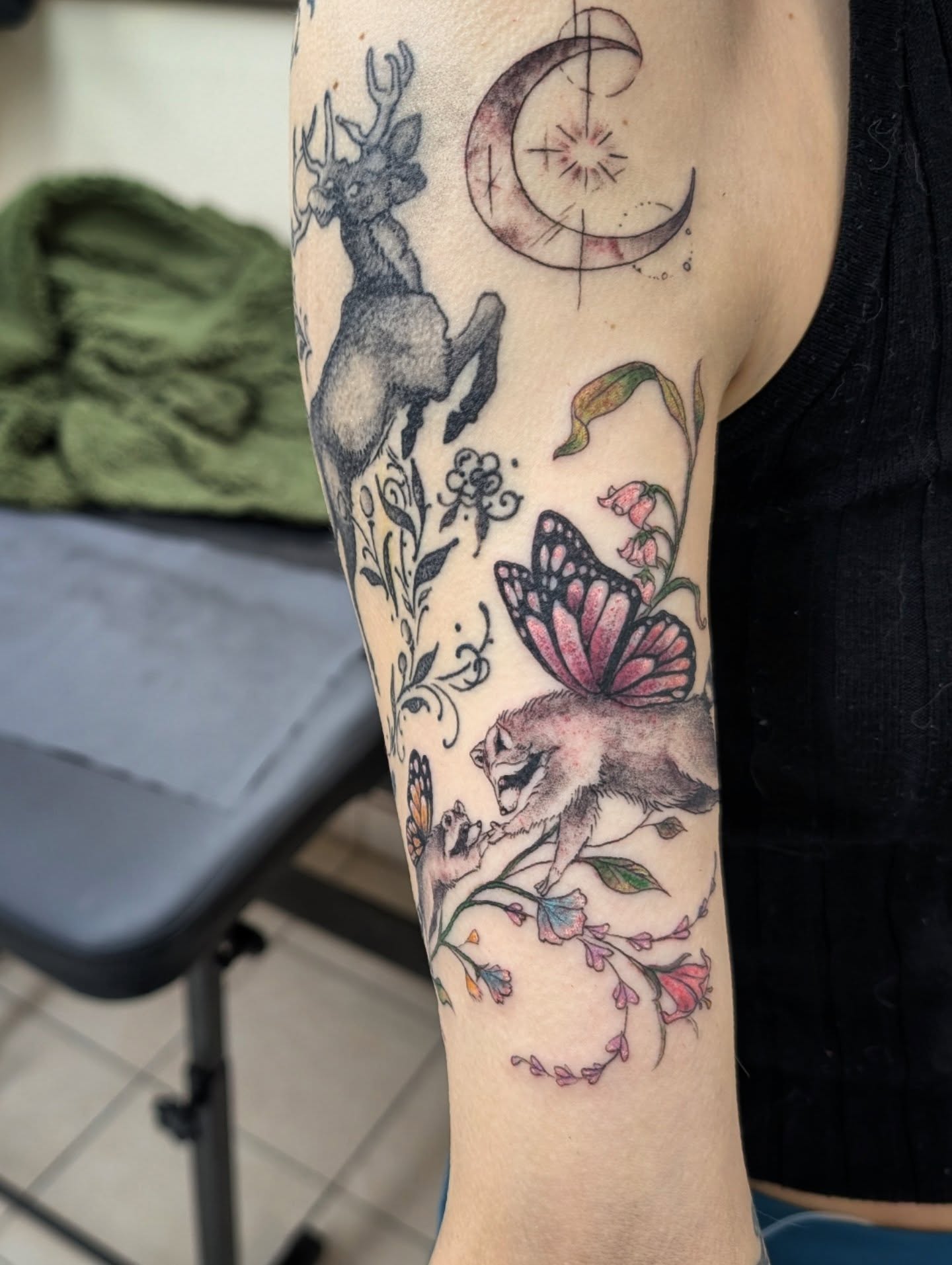 Deer, butterfly, flowers, moon realism tattoo on the forearm by Katherine