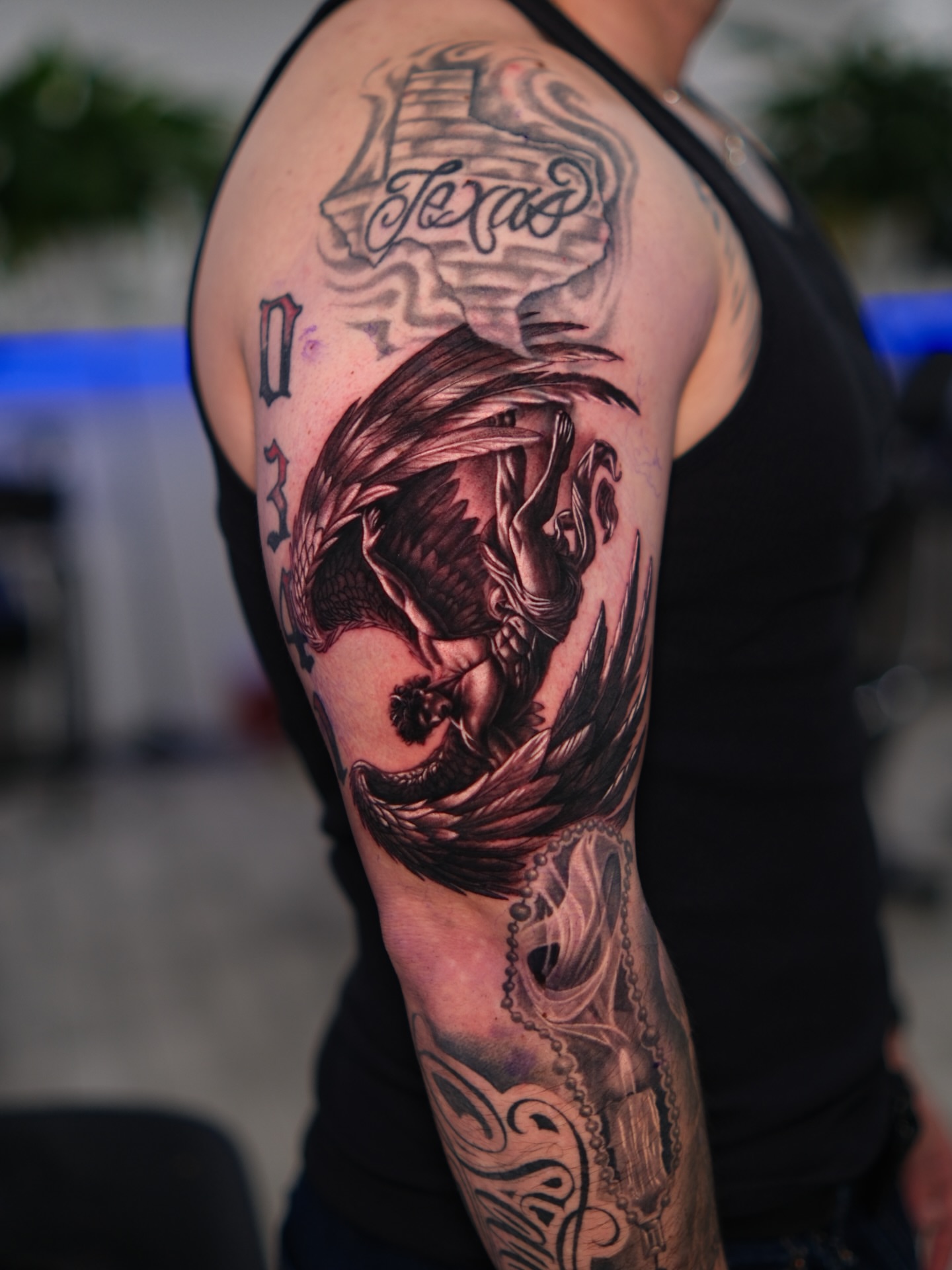 Dragon realism tattoo on the upper arm by Dallas tattoo artist