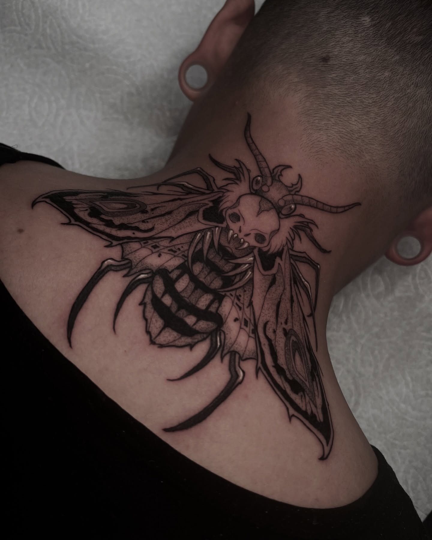 Bee with skull dark realism tattoo on the shoulder by Las Vegas Tattoo Artist