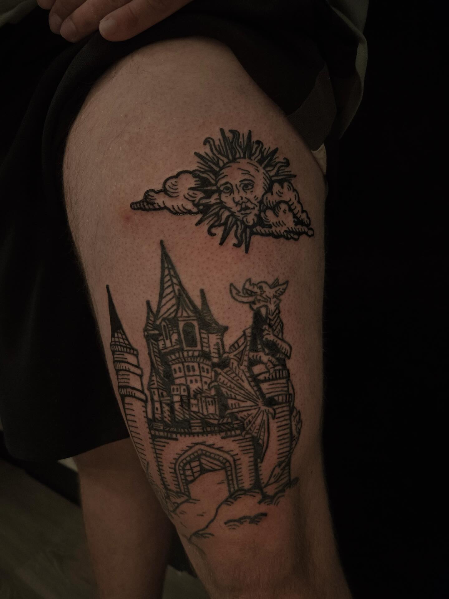 Castle and sun black and grey tattoo on the thigh by ashley blyght