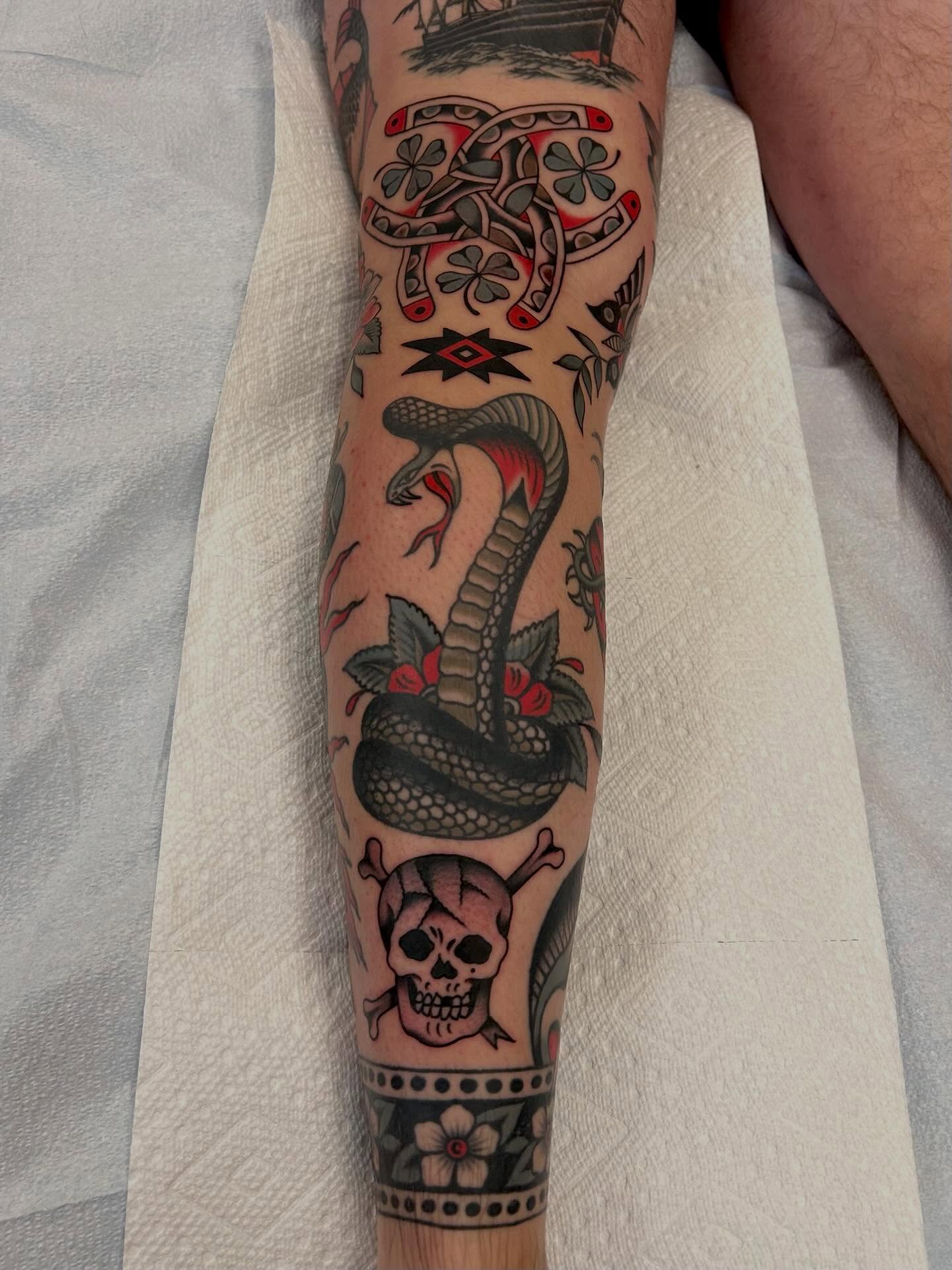 Snake and skull American traditional tattoo on the forearm by Christian Lasyone