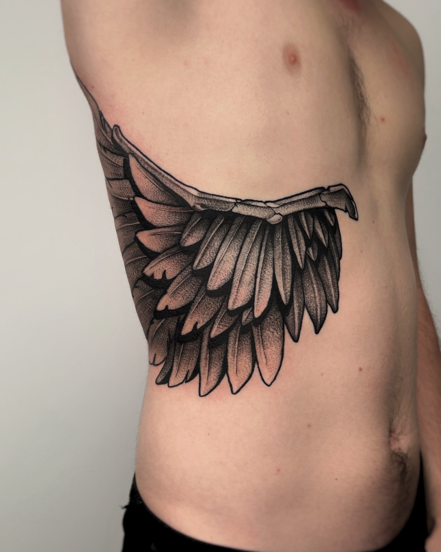 Wings dotwork tattoo on the ribs by Kuya, Berkeley, California