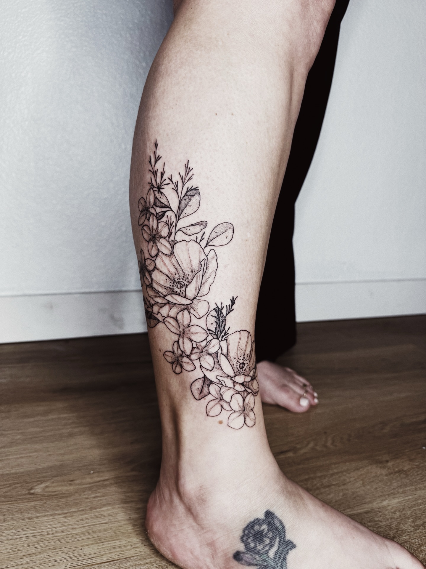 Floral arrangement black and grey tattoo on the calf by πΉπ°π½πππ΄π½ πΆπ»π΄π½π½, North Logan, Utah