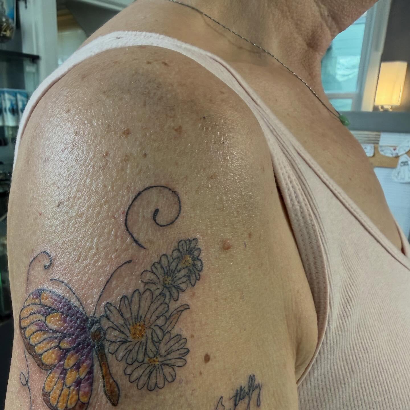 Butterfly and flowers realism tattoo on the shoulder by Jillian Pardy