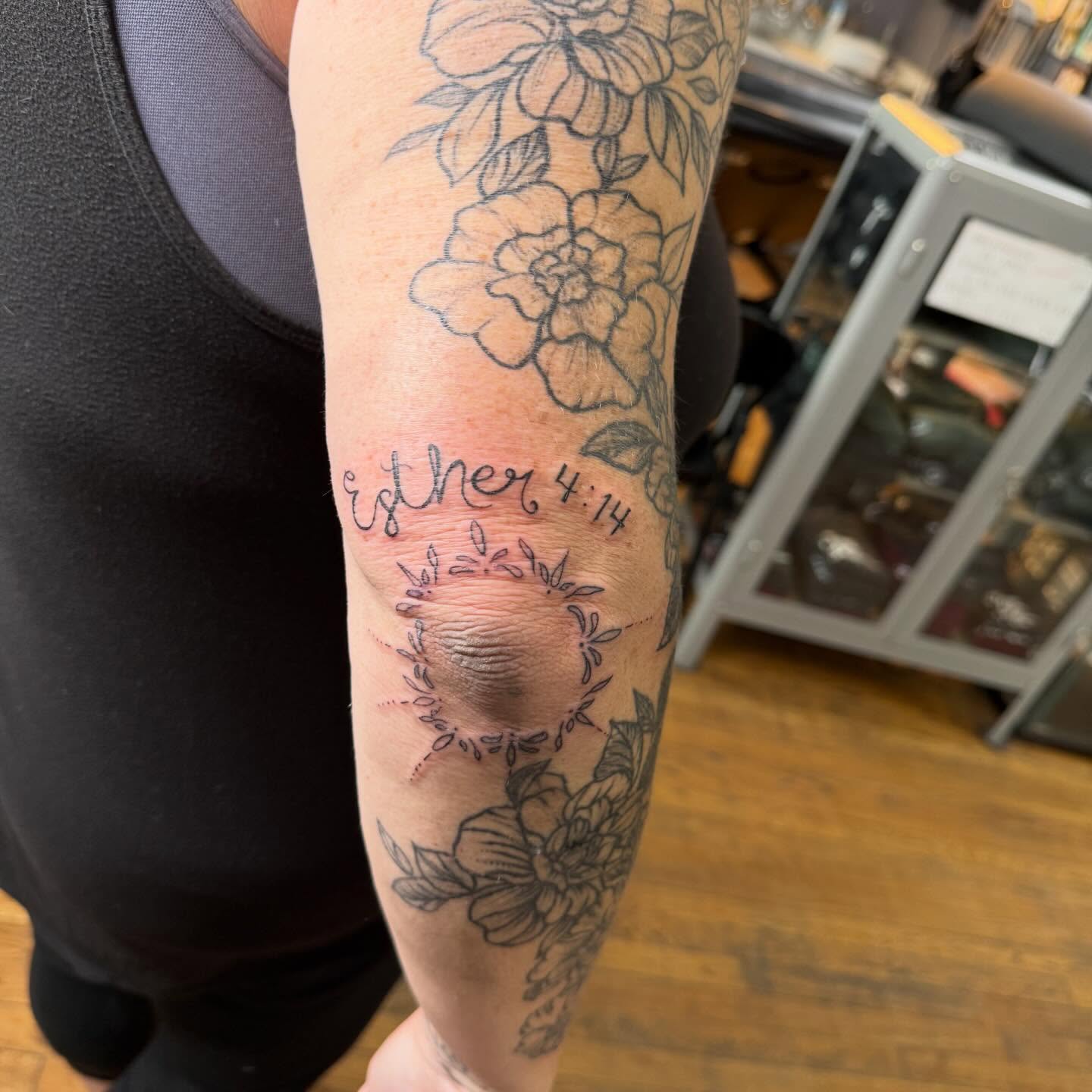 Flowers and script black and grey tattoo on the forearm by Jillian Pardy