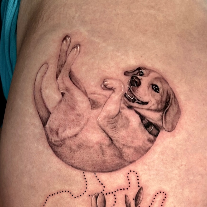 Puppy in hands realism tattoo on the shoulder by Longtea