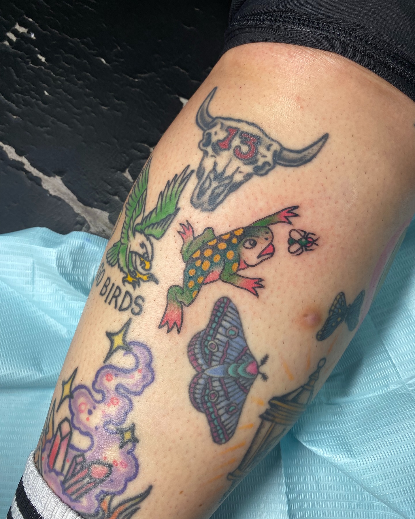 Tattooed birds and skull American traditional tattoo on the thigh by Ramsie Segura-Andrews
