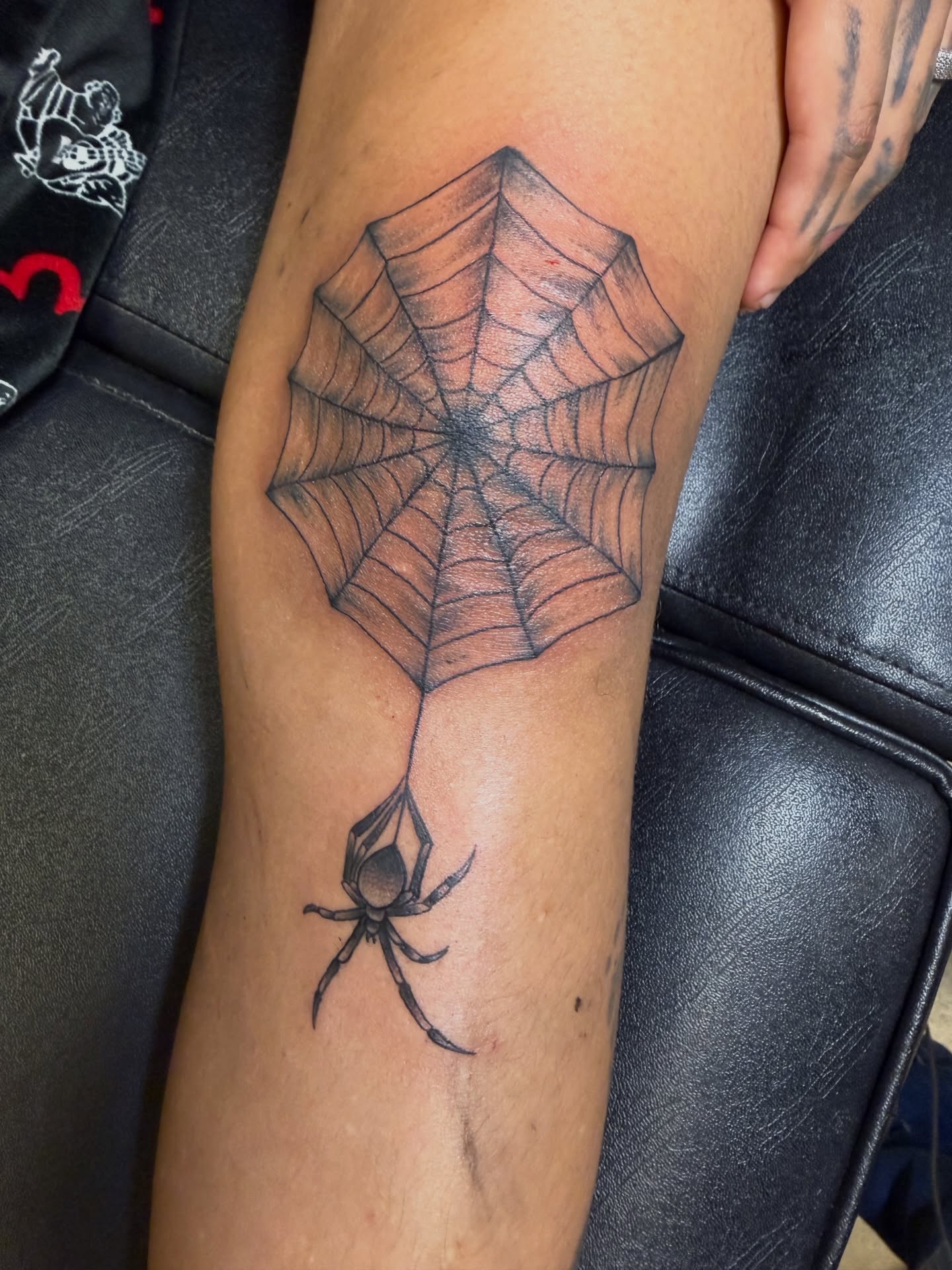 Spider web black and grey tattoo on the forearm by Humberto Vega