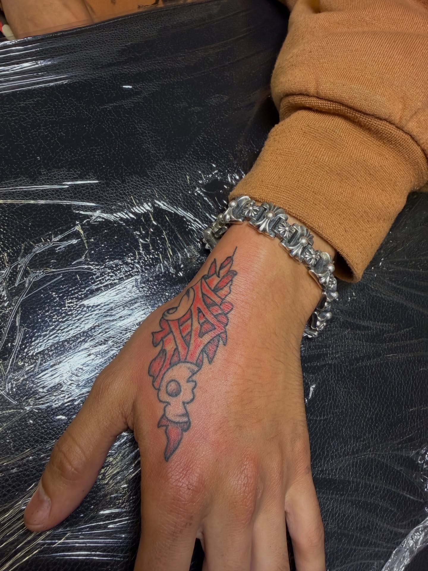 Skull and flame American traditional tattoo on the hand by Humberto Vega
