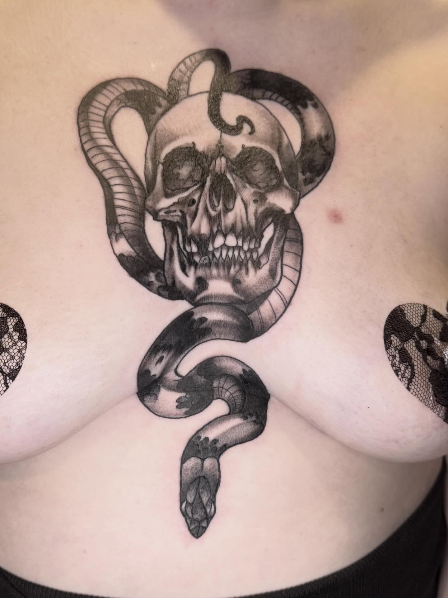 Skull and snake realism tattoo on the chest by Mike Bean, Minneapolis, Minnesota