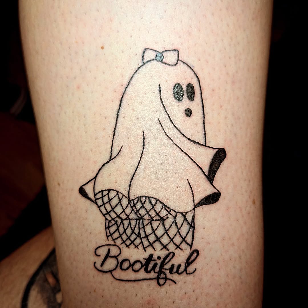 Ghost with fishnet stockings and text tattoo on the forearm by Matt Mahl