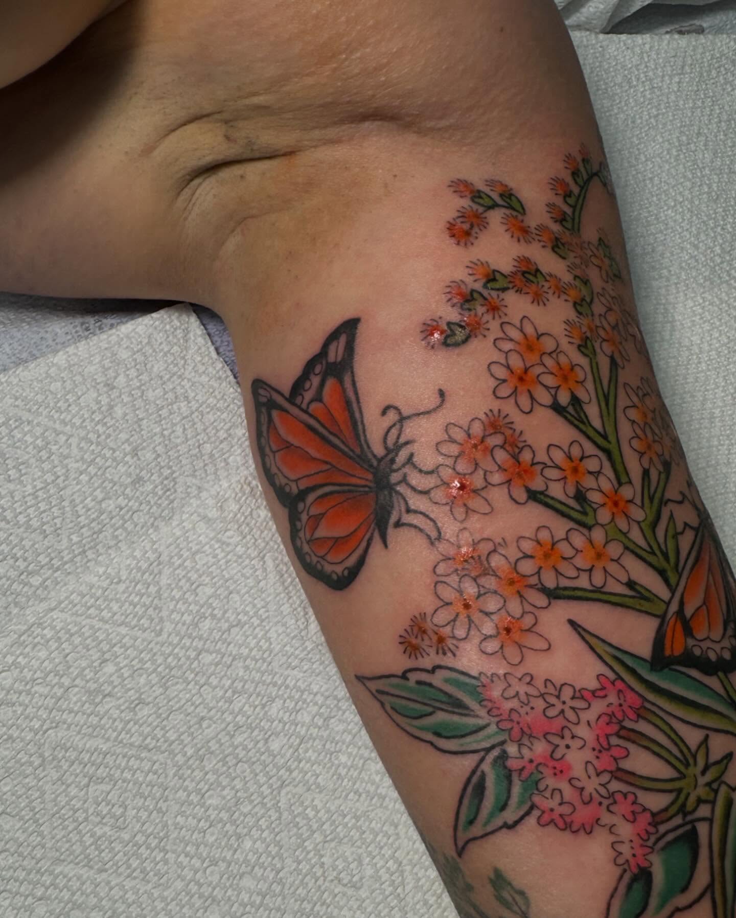 Butterfly and flowers new school tattoo on the forearm by B