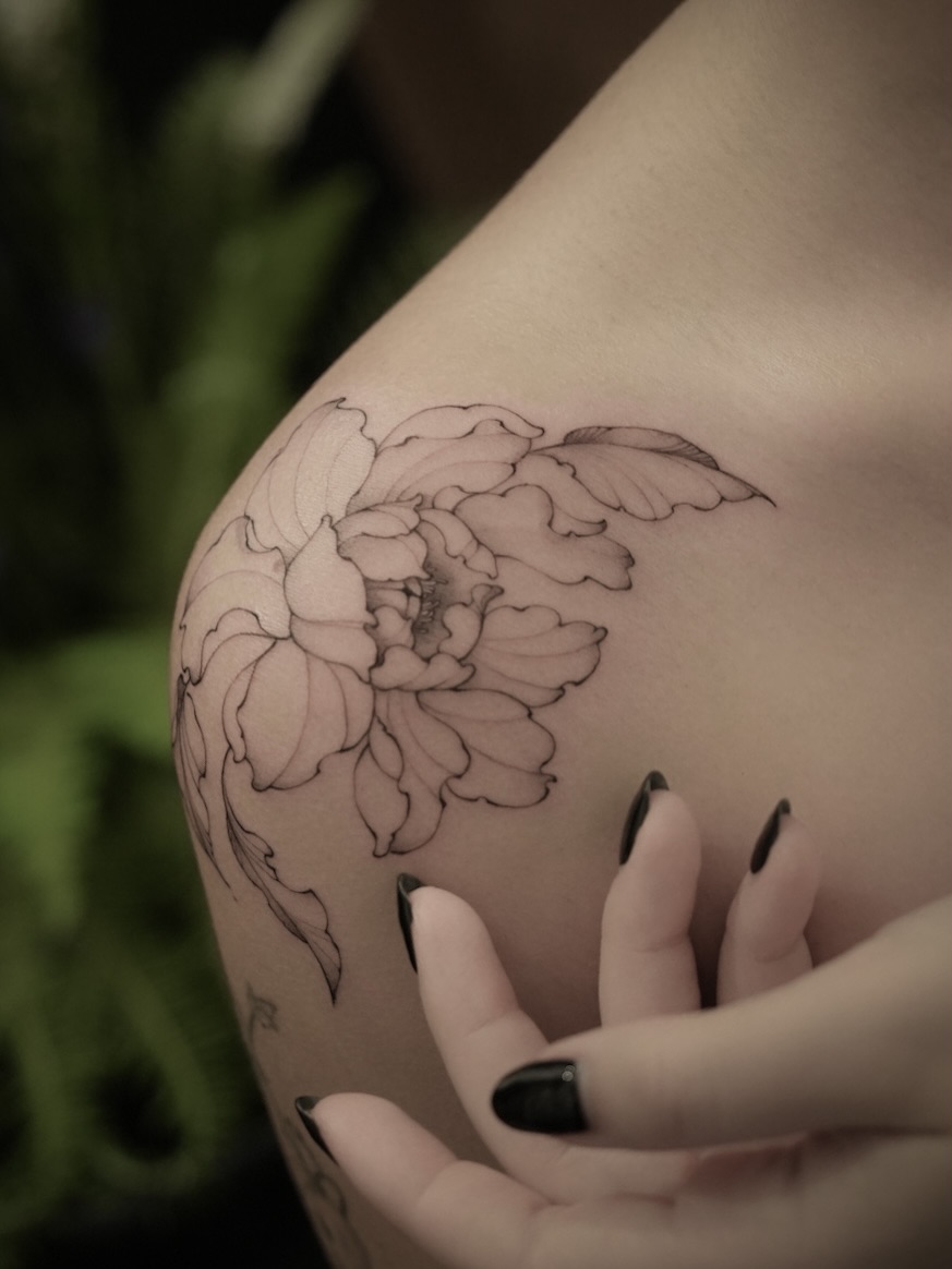 Peony black and grey tattoo on the shoulder by Junh Tattoo NYC