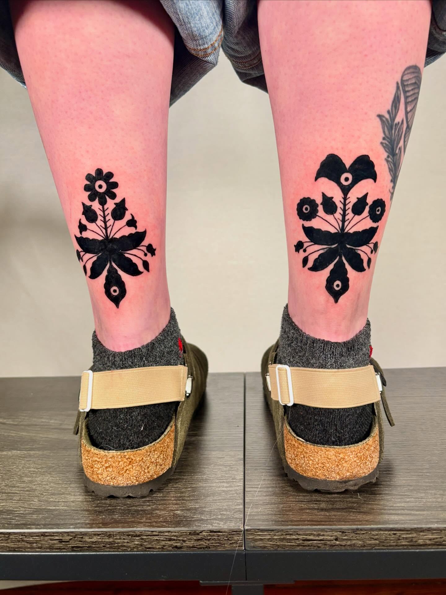 Floral pattern black and grey tattoo on the calf by Davie Tattoos