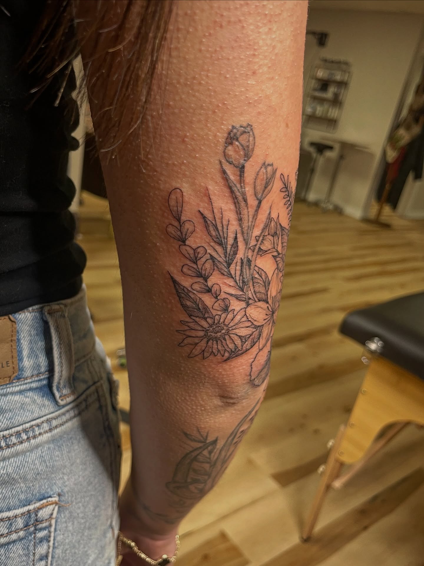 Floral arrangement black and grey tattoo on the forearm by Francesca Siwa