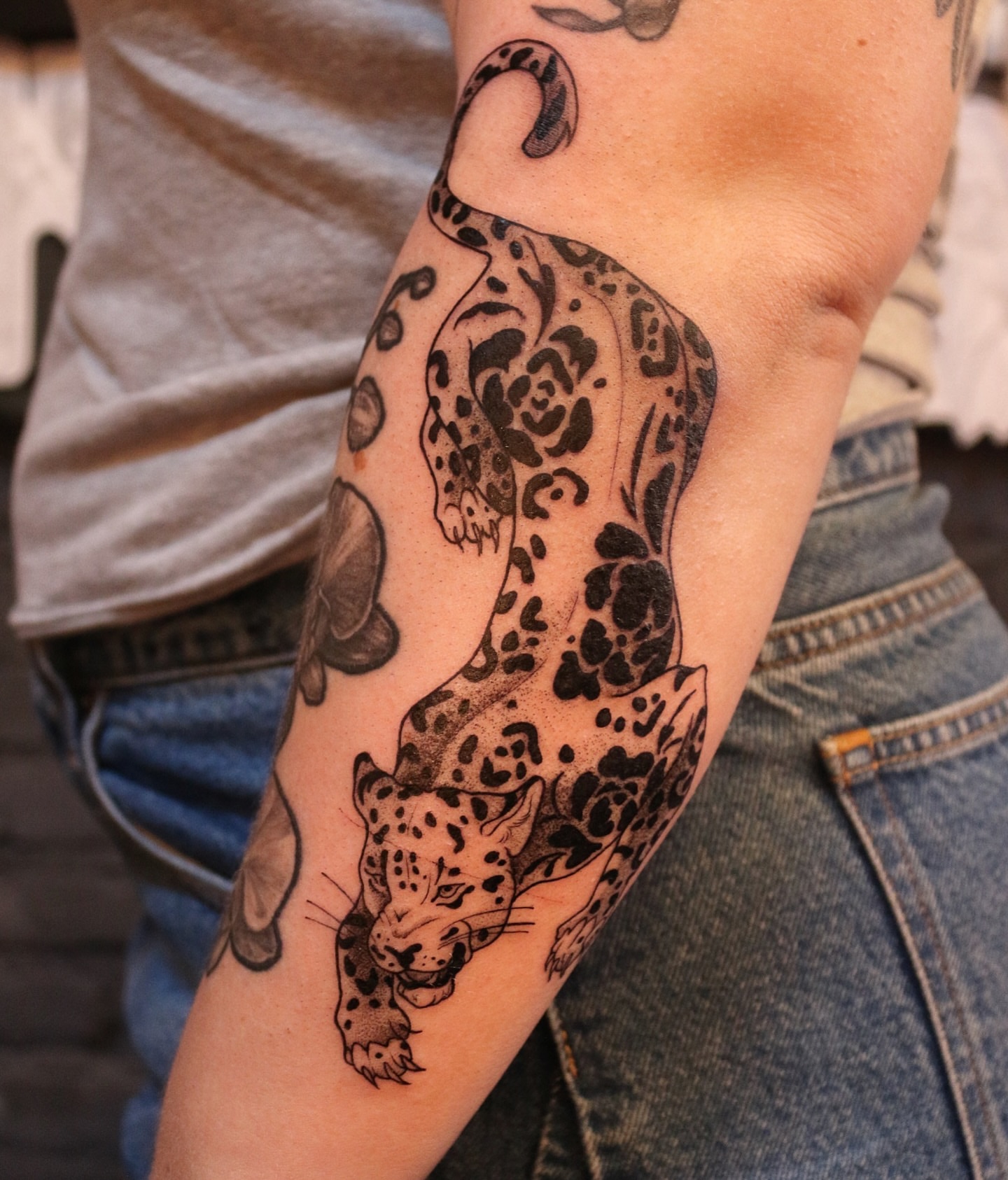 Leopard black and grey tattoo on the forearm by Summer Balcom M.