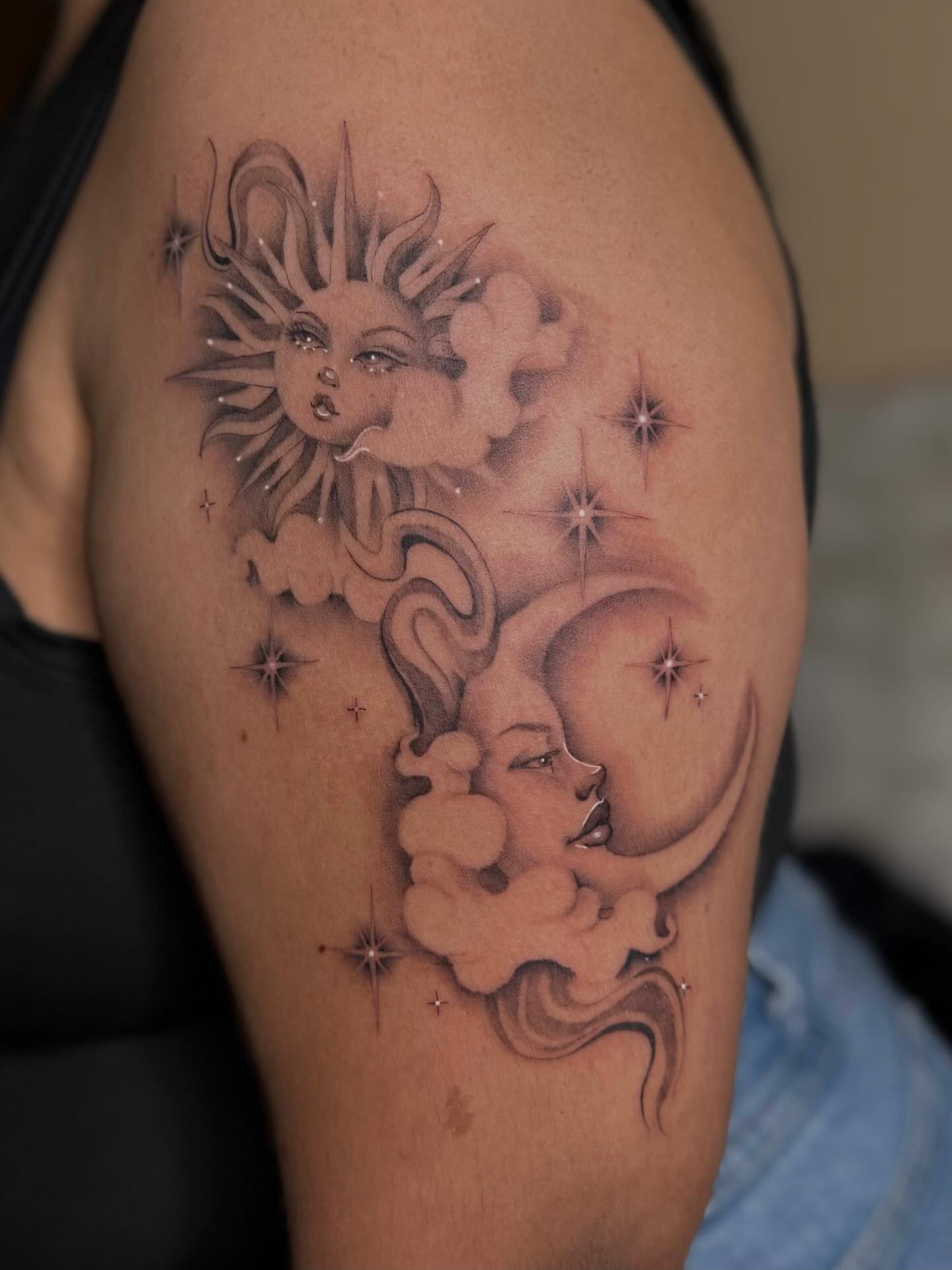 Sun and moon black and grey tattoo on the shoulder by Jas Knight