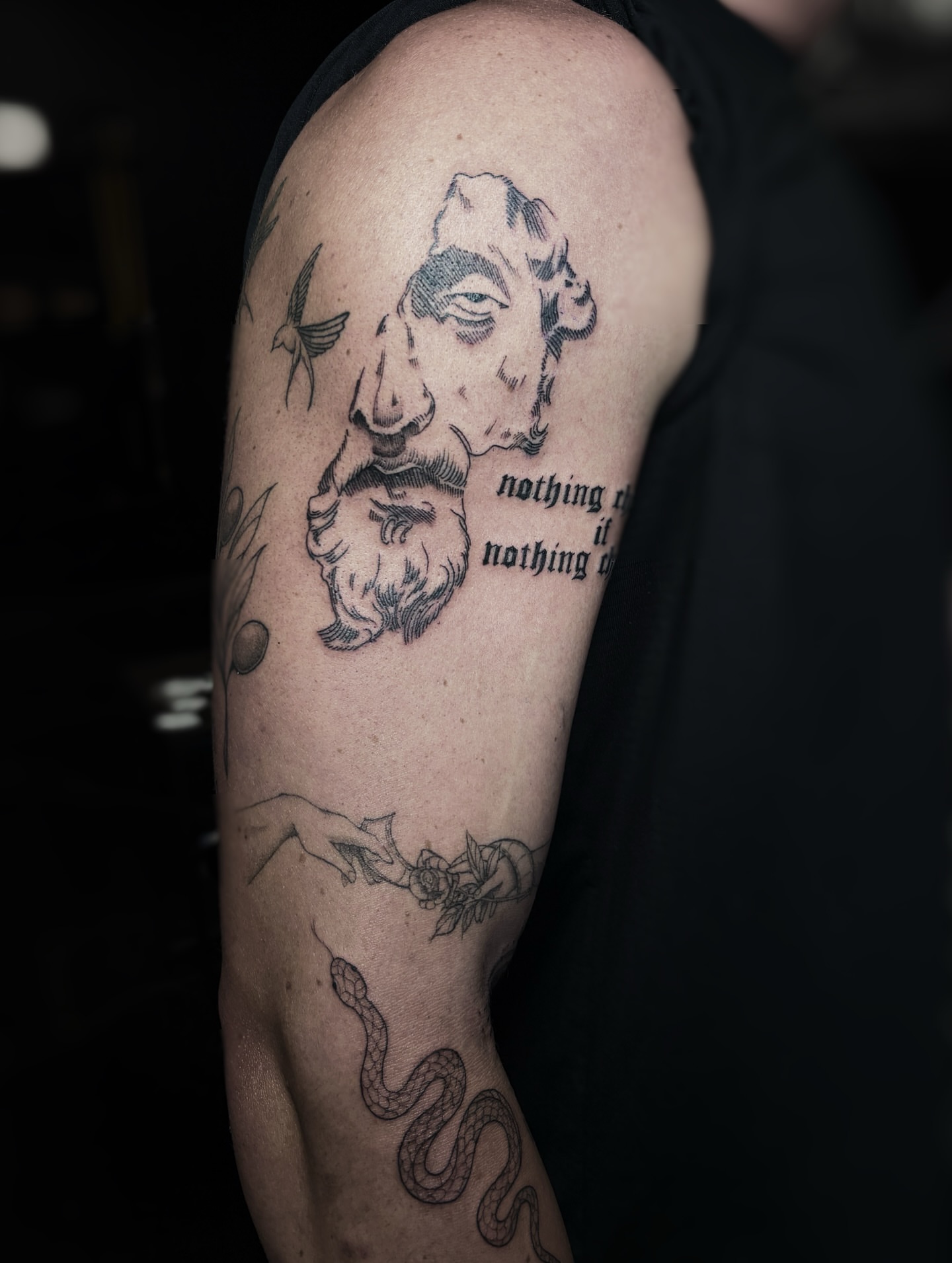 Portrait with quote realism tattoo on the upper arm by Fine Line Tattoo Artist