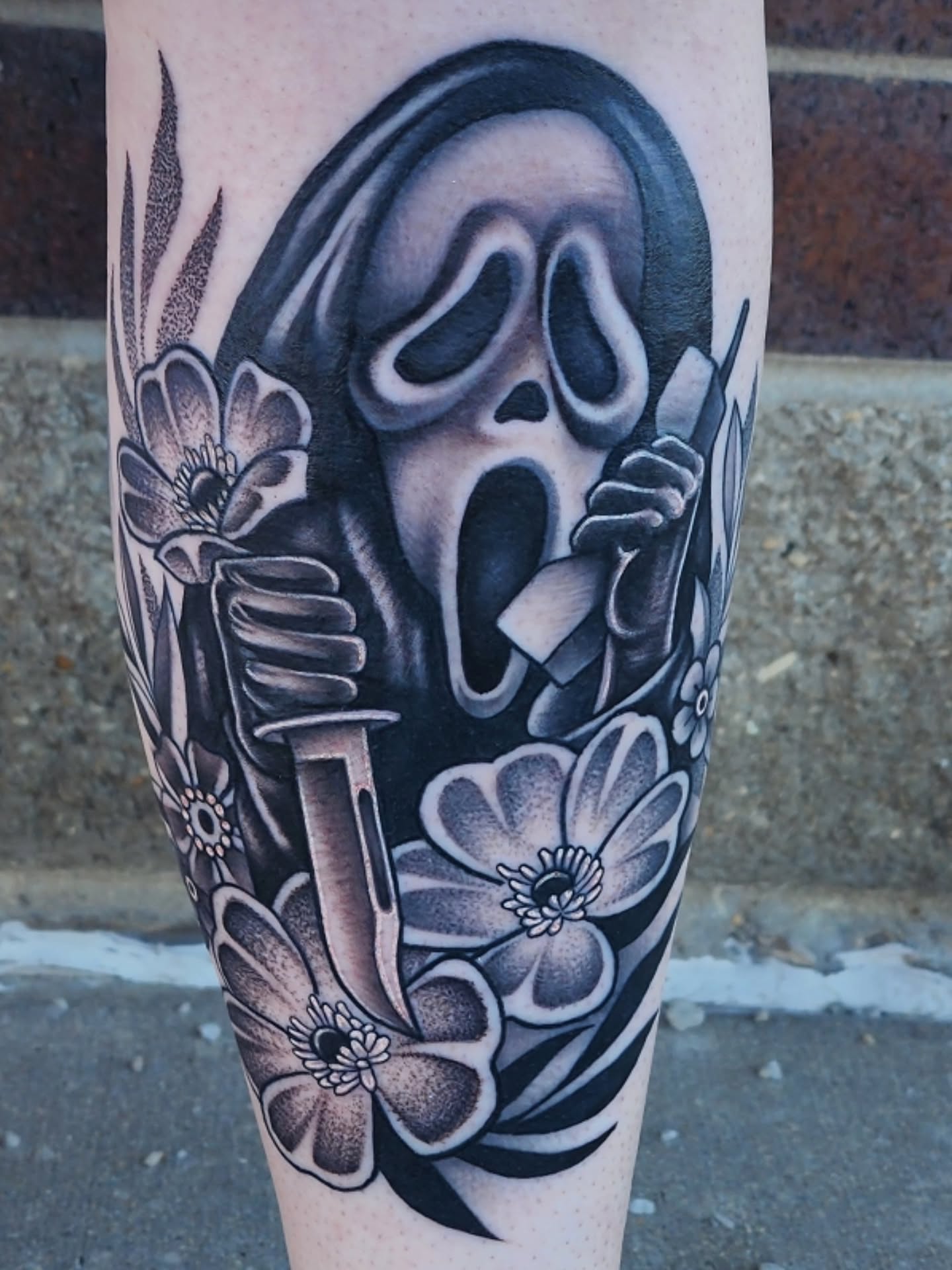 Scream mask realism tattoo on the forearm by Shawna Goettsche