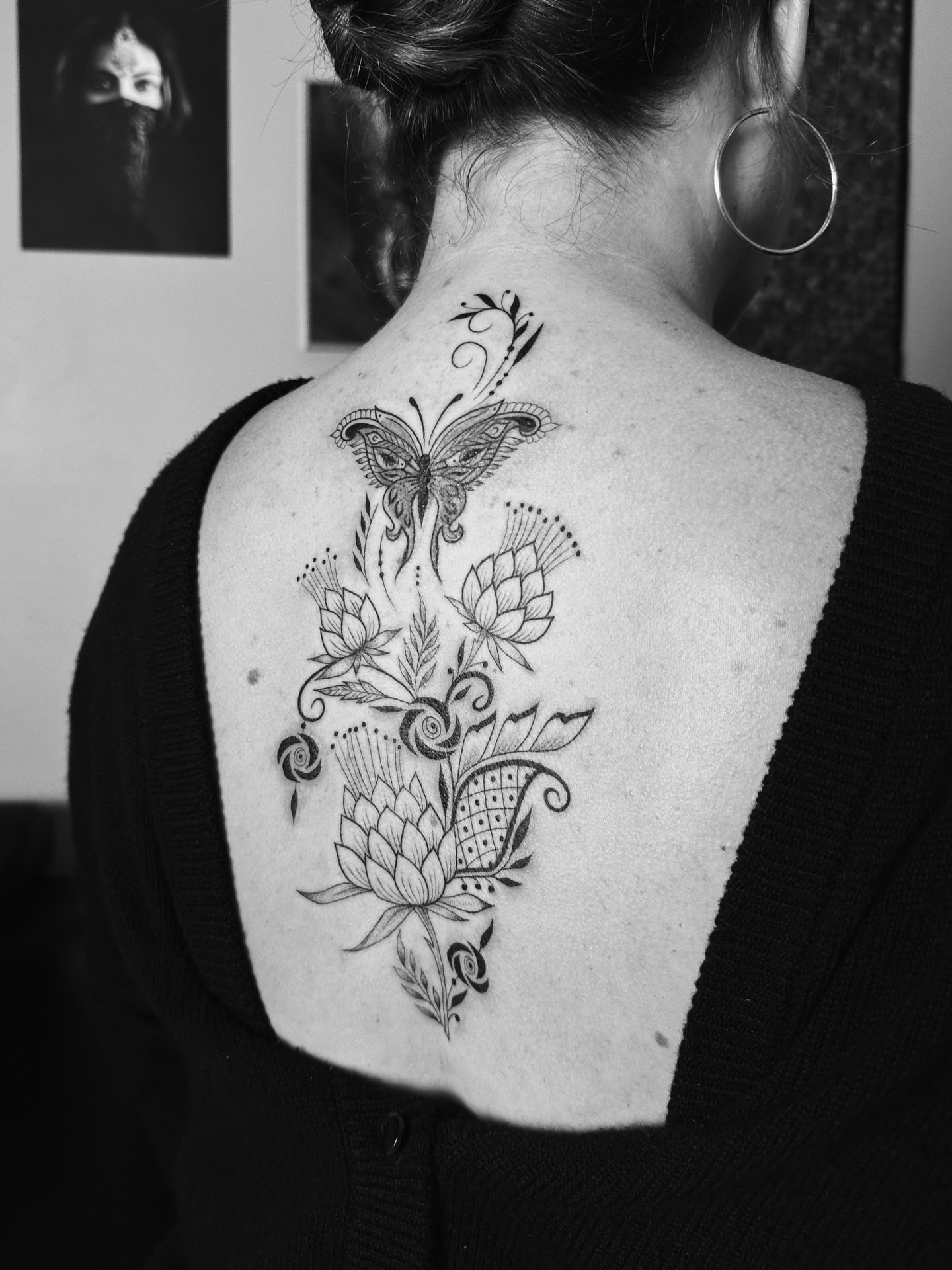 Butterfly and floral arrangement ornamental tattoo on the back by Sabreena Haque